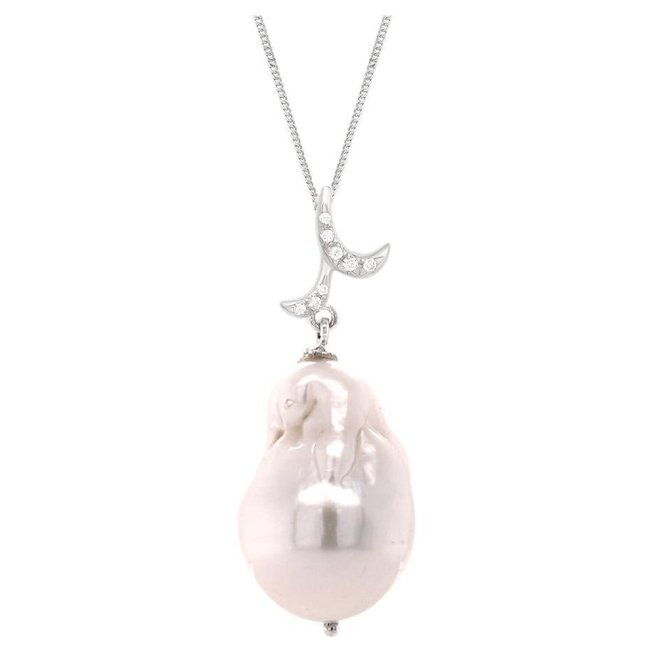 Emulating femininity and glamour, the Whispering collection is full of colour and form. Inspired by the twisting, sculptural shape of the exotic Orchid flower. Whispering baroque pearl drop pendant, cascading from a diamond filigree twirl. This