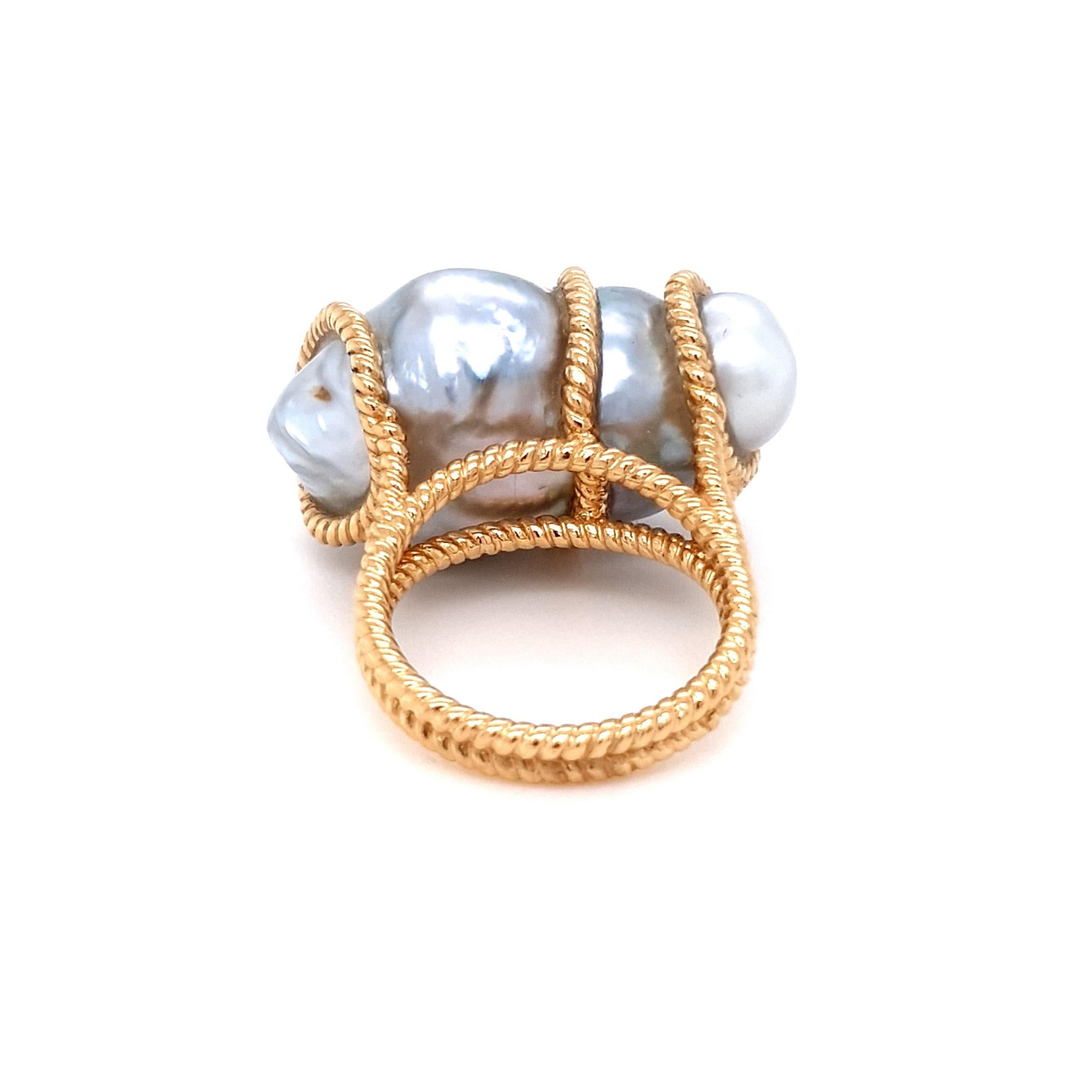 Indulge in unparalleled elegance with this one-of-a-kind ring, featuring a magnificent 41.8ct baroque pearl that exudes iridescent allure at its centre. This exquisite gem is cradled by a meticulously crafted 18ct yellow gold band, adorned with a