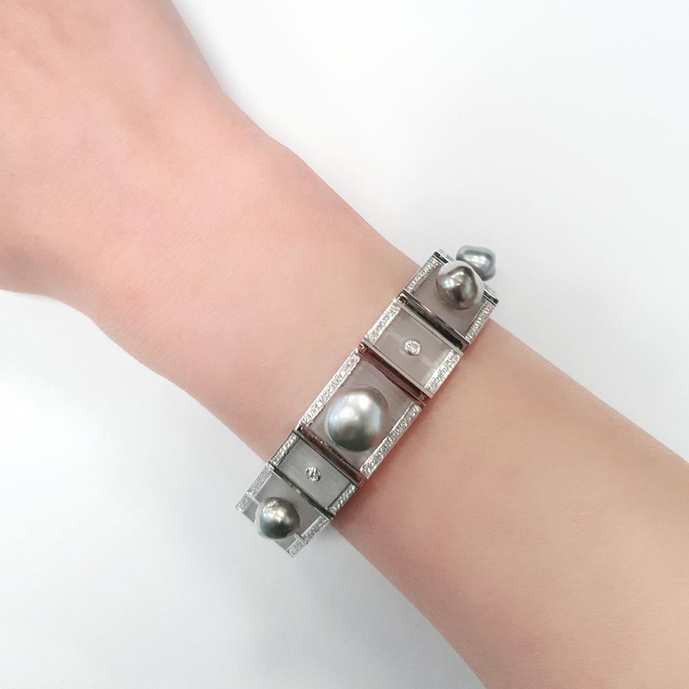 This one-of-a-kind bracelet is a striking piece, crafted for those who love to make a statement with their jewellery. It showcases a series of expertly reticulated, striated frosted rock crystal panels, designed for maximum comfort, each encased
