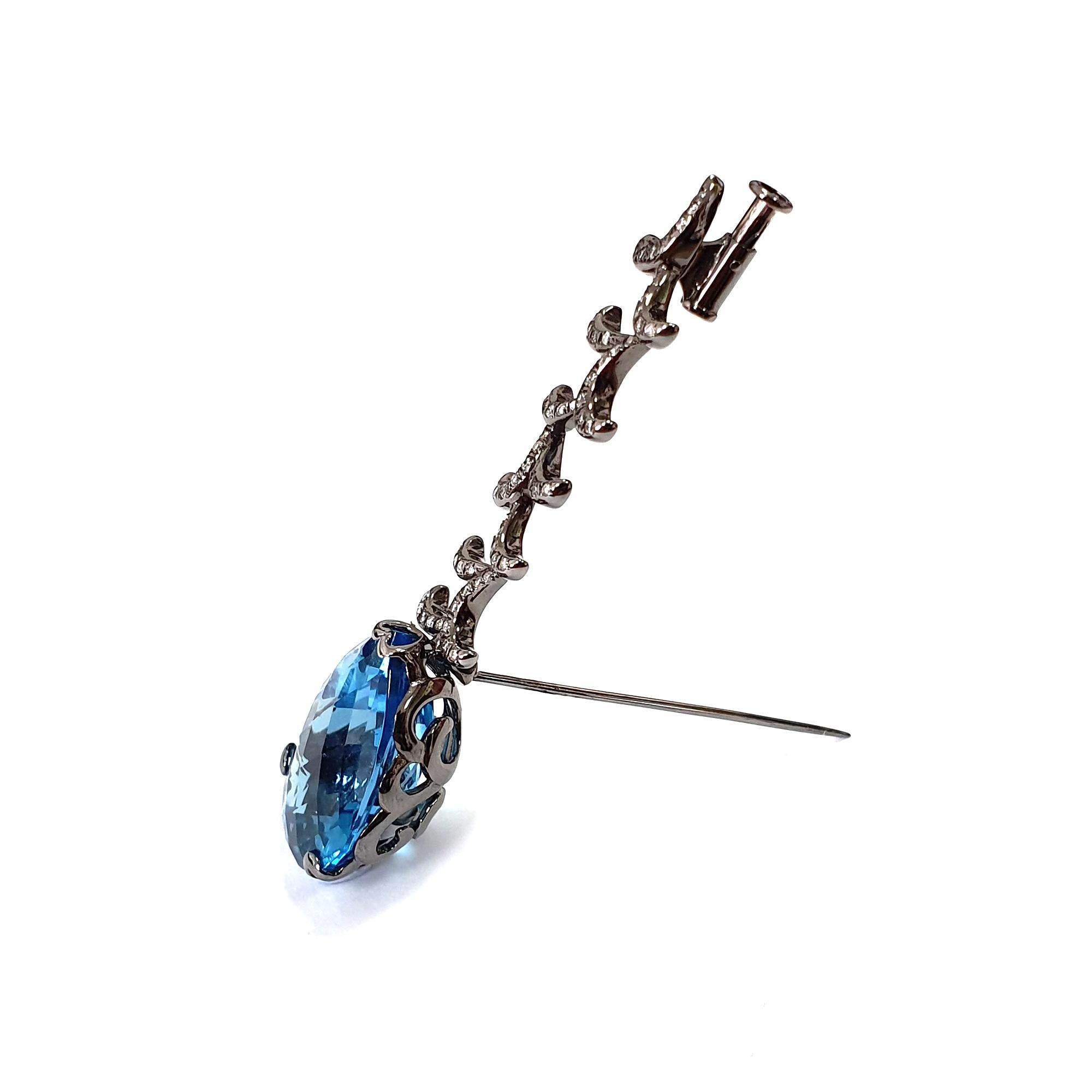 Description:
Whispering brooch with 17ct blue topaz and 24ct white diamonds set in black rhodium plate on 18ct white gold. 

*Please note, the stone is more of a London blue topaz. Our photographs don't captured the true colour of the London