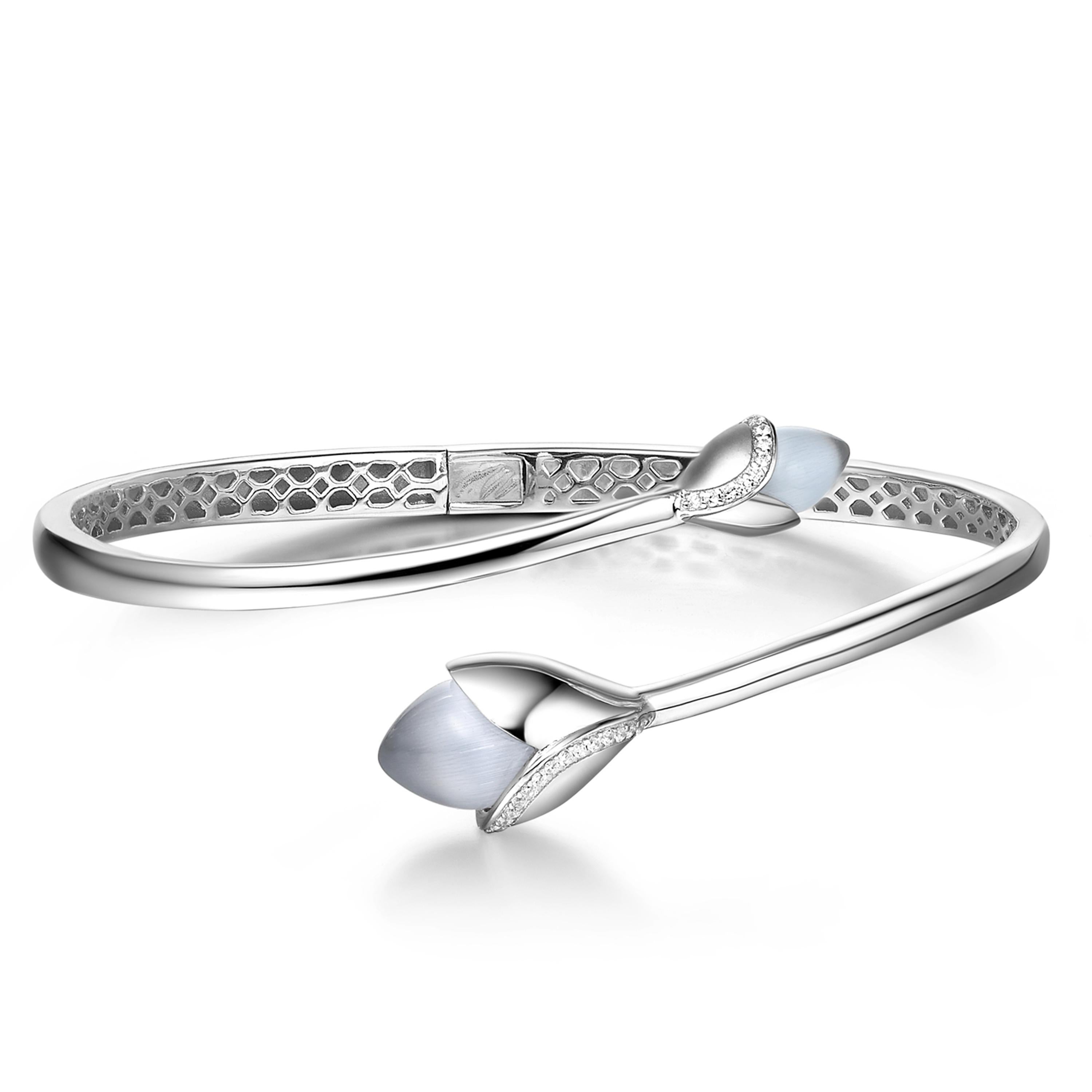 Description:
Blossom with the Magnolia bangle. Featuring two grey cat’s eye stone and cubic zirconia, set in white rhodium plate on sterling silver.

Inspiration:
This capsule collection blossoms with the pretty cat’s eyes and dew drops of 8 hearts
