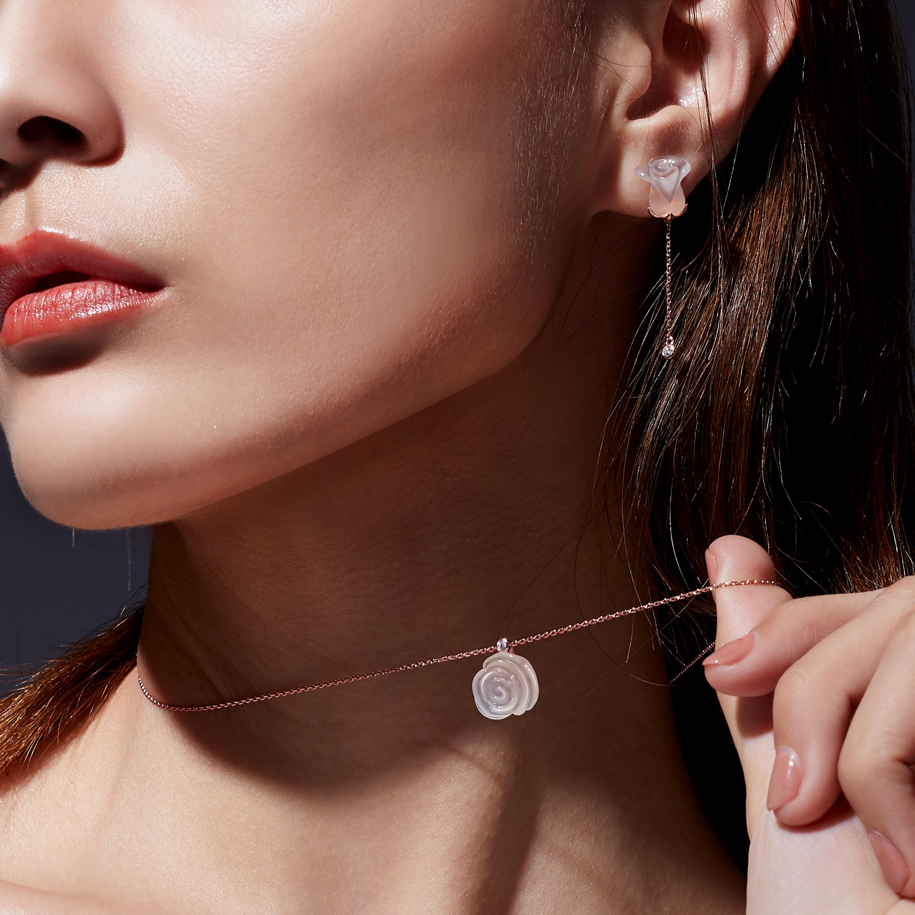 Blossom like the sweet roses with Fei Liu’s Chalcedony Rose Collection. The necklace and earrings set features delicately hand-carved chalcedony rose petals sparkling with the finest cubic zirconia set in 18 karat rose gold plate on sterling