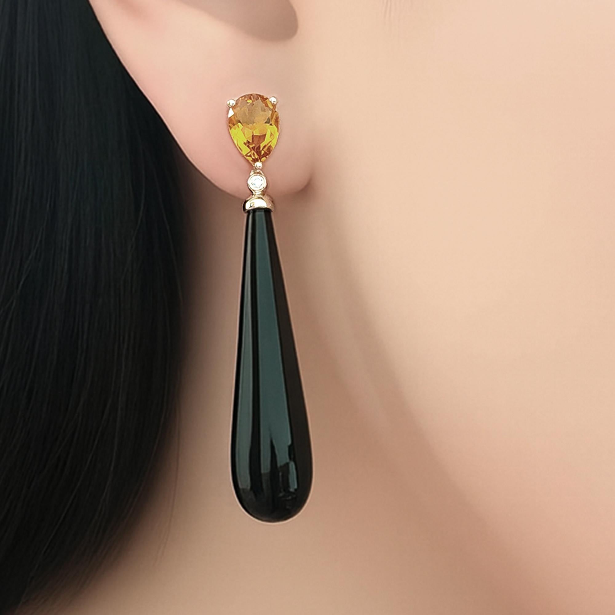 Questi orecchini a goccia asimmetrici, uno studio sulla dualità e sull'eleganza, abbinano il caldo citrino (1,10 carati) al ricco granato (1,50 carati), ciascuno incastonato nell'oro giallo 14 carati e accentuato da un sussurro di diamanti a taglio