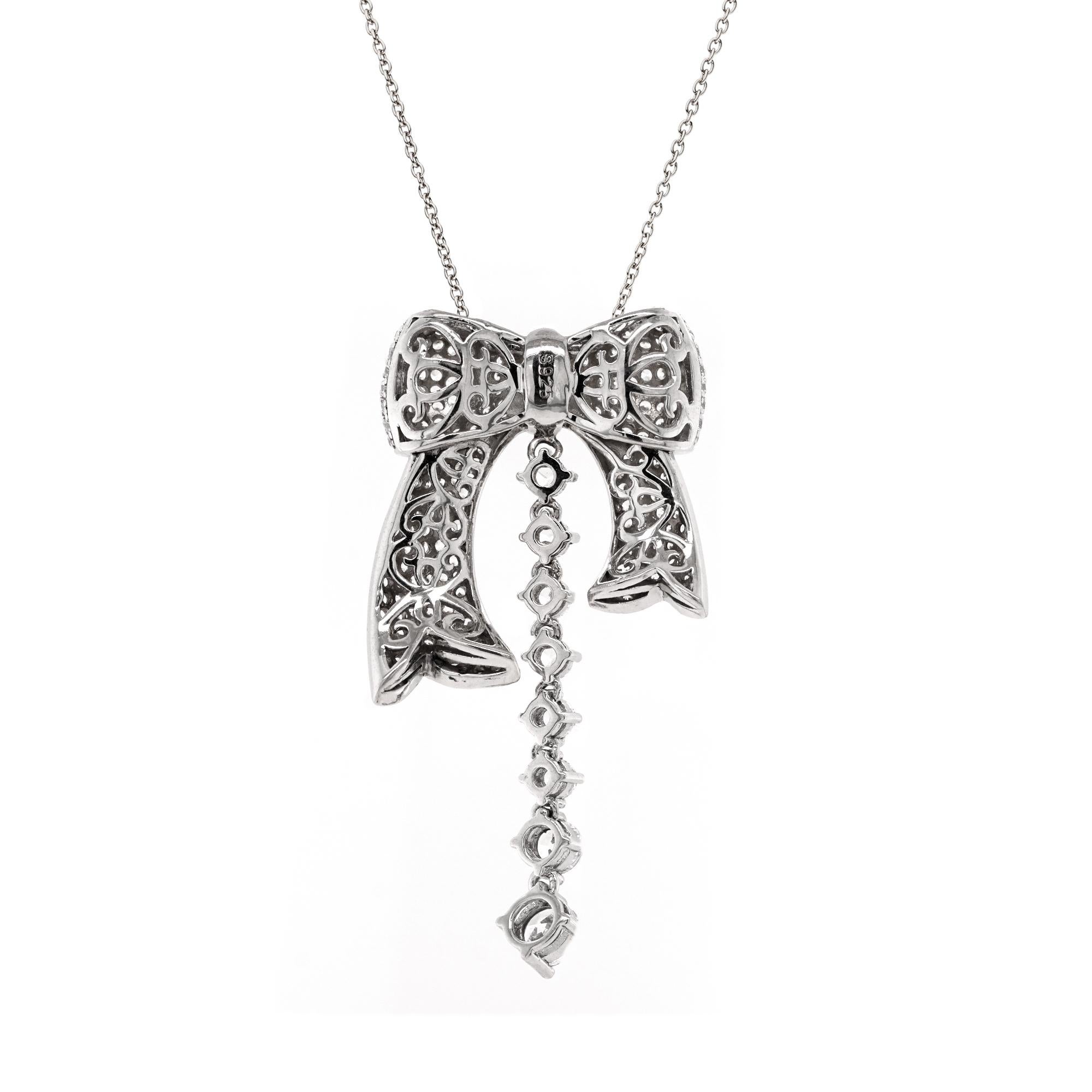 A celebration of artistry and opulence, this exquisite pendant necklace reimagines the classic bow motif in sterling silver, encrusted with a tapestry of brilliant-cut diamonds. Each curve of the bow shimmers with meticulous pavé setting, reflecting