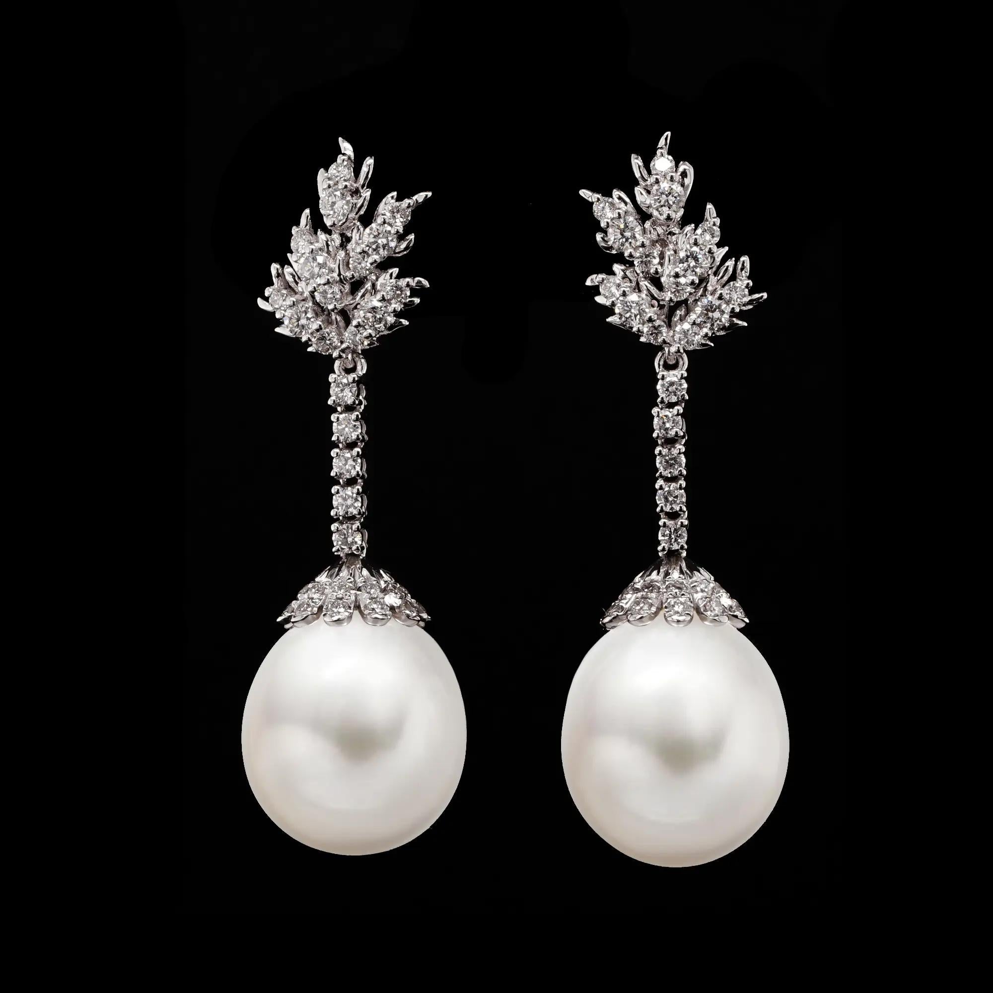Graziosi e luminosi, questi orecchini a goccia in platino abbinano il fascino senza tempo delle perle alla brillantezza dei diamanti da 0,784 carati. Ogni orecchino presenta una lucente perla bianca sospesa da una linea verticale di diamanti, che