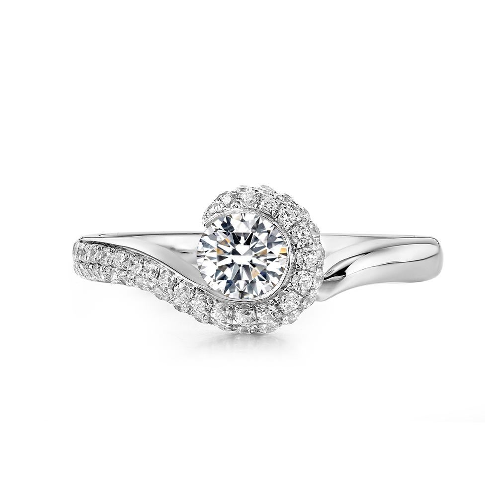 The Arabella Engagement Ring is a true testament to opulence and elegance. Crafted within platinum, this captivating piece showcases a dazzling centre diamond that radiates brilliance from every angle. The intricate twist design adds a touch of