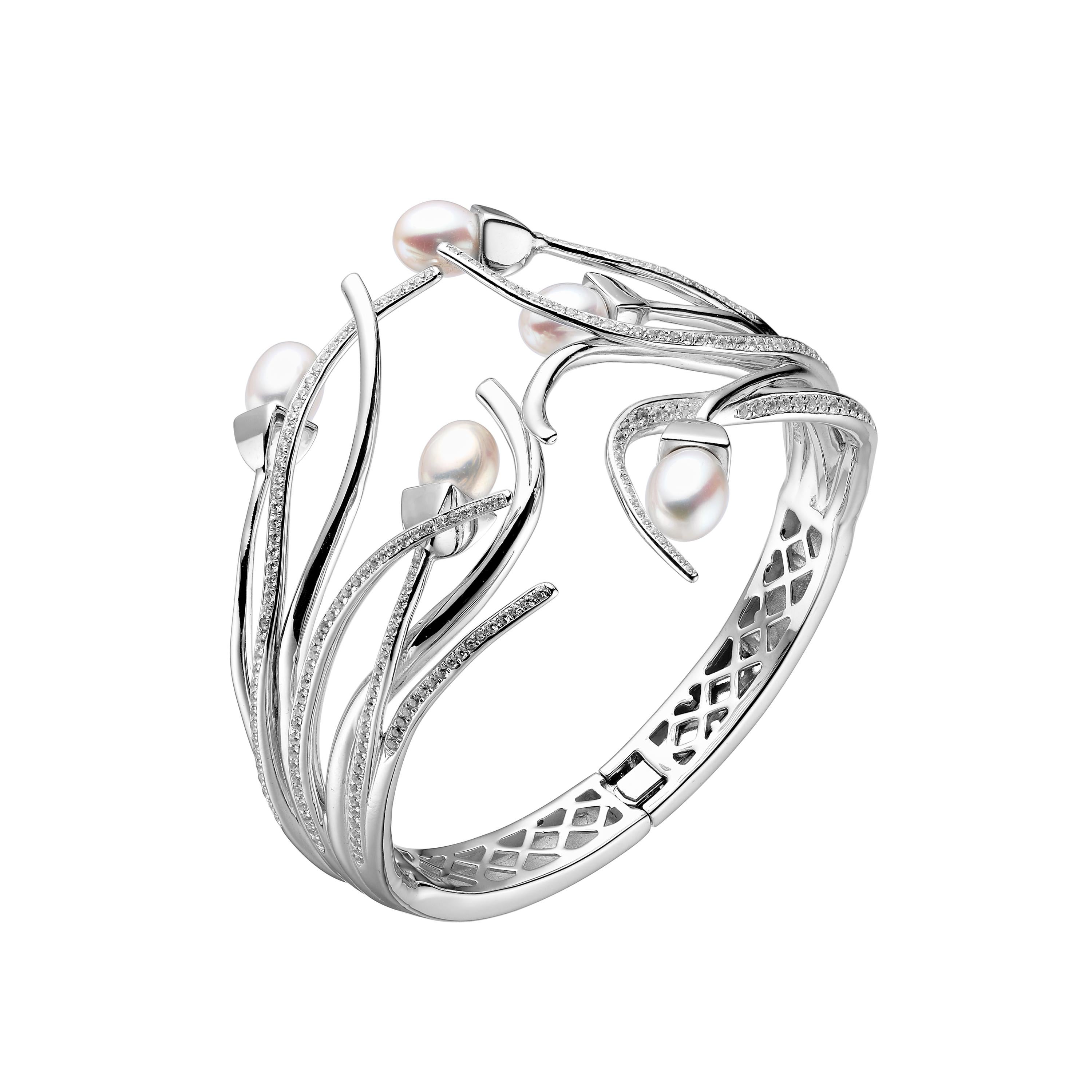Description:
Snowdrop multi-pearl bangle with freshwater pearls and luxurious cubic zirconia set stems, set in white rhodium plate on sterling silver.

Inspiration:
The natural beauty of the English rose is captured in the Rose Collection double