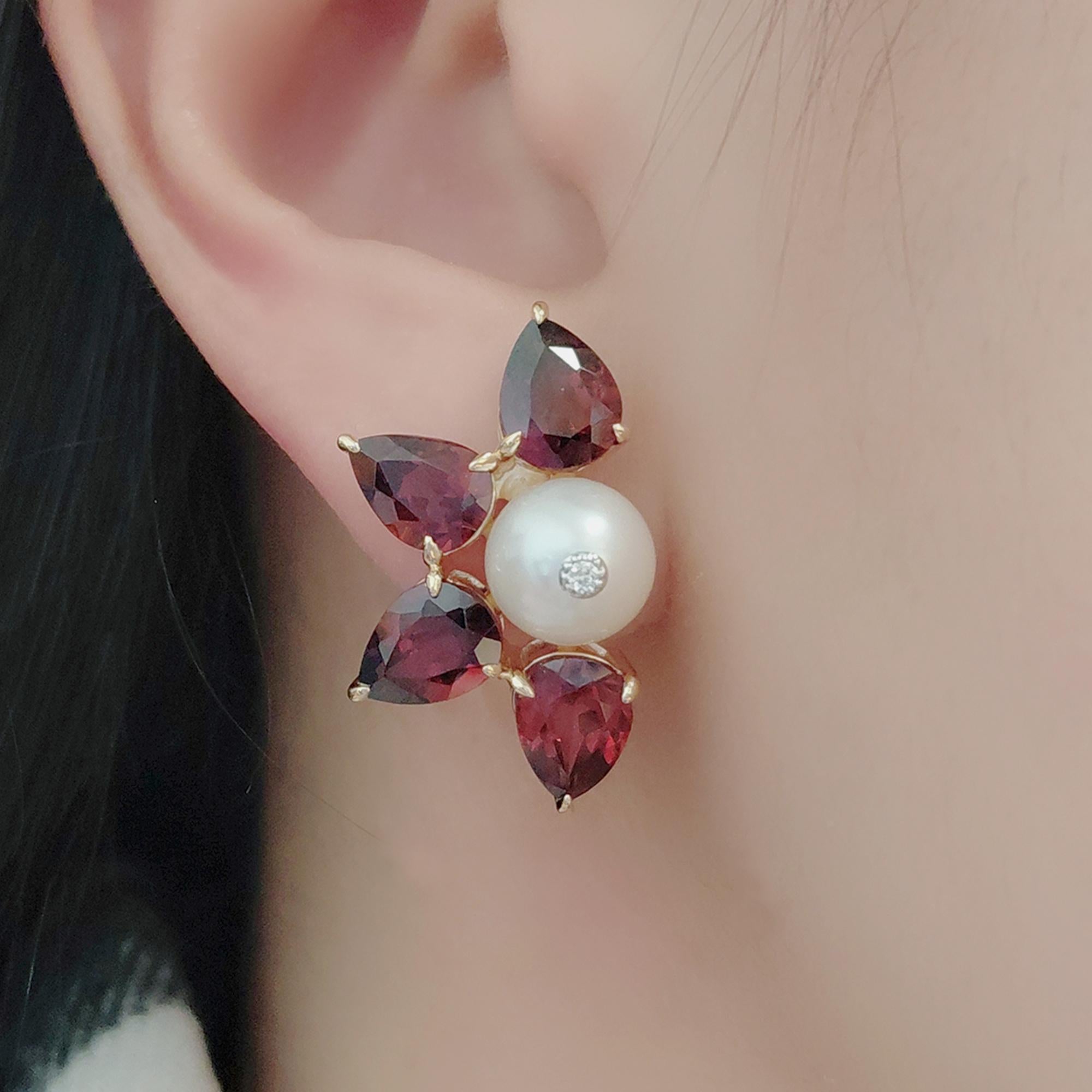 Un'ode radiosa al calore e alla raffinatezza, questi orecchini a perno abbinano il profondo bagliore cremisi dei granati (per un totale di 11,72 carati) alla morbida lucentezza delle perle centrali, ciascuna baciata da un delicato accento di