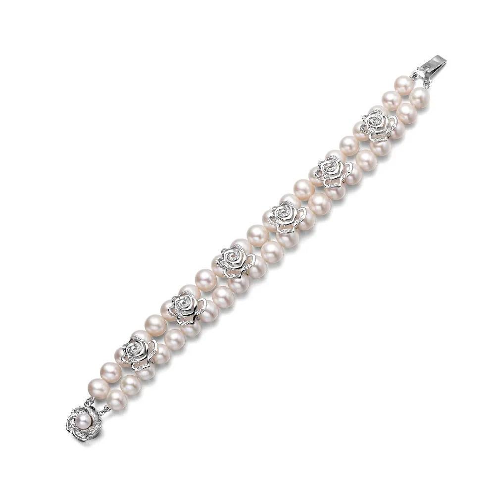 The Rose Double Pearl Strand Bracelet is a refined piece that perfectly balances classic elegance with intricate detailing. At 7 inches in length, this bracelet features two strands of hand-knotted pearls, each chosen for its radiant lustre.