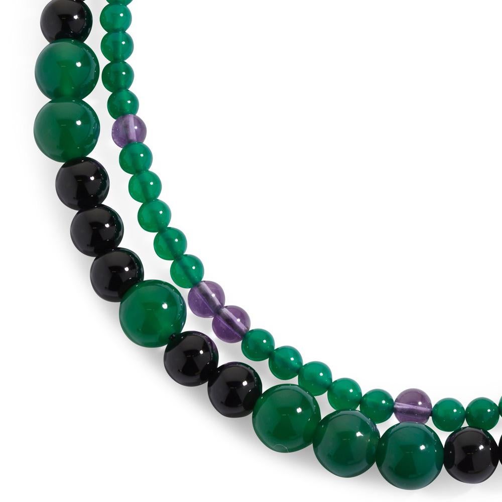 Vibrancy and colour combine to create the Two-Strand Gemstone Bead Necklace, an effortlessly wearable piece for collectors. Purposefully composed with a complementary mix of semi-precious beads, it features graduated amethyst, onyx, and green agate,