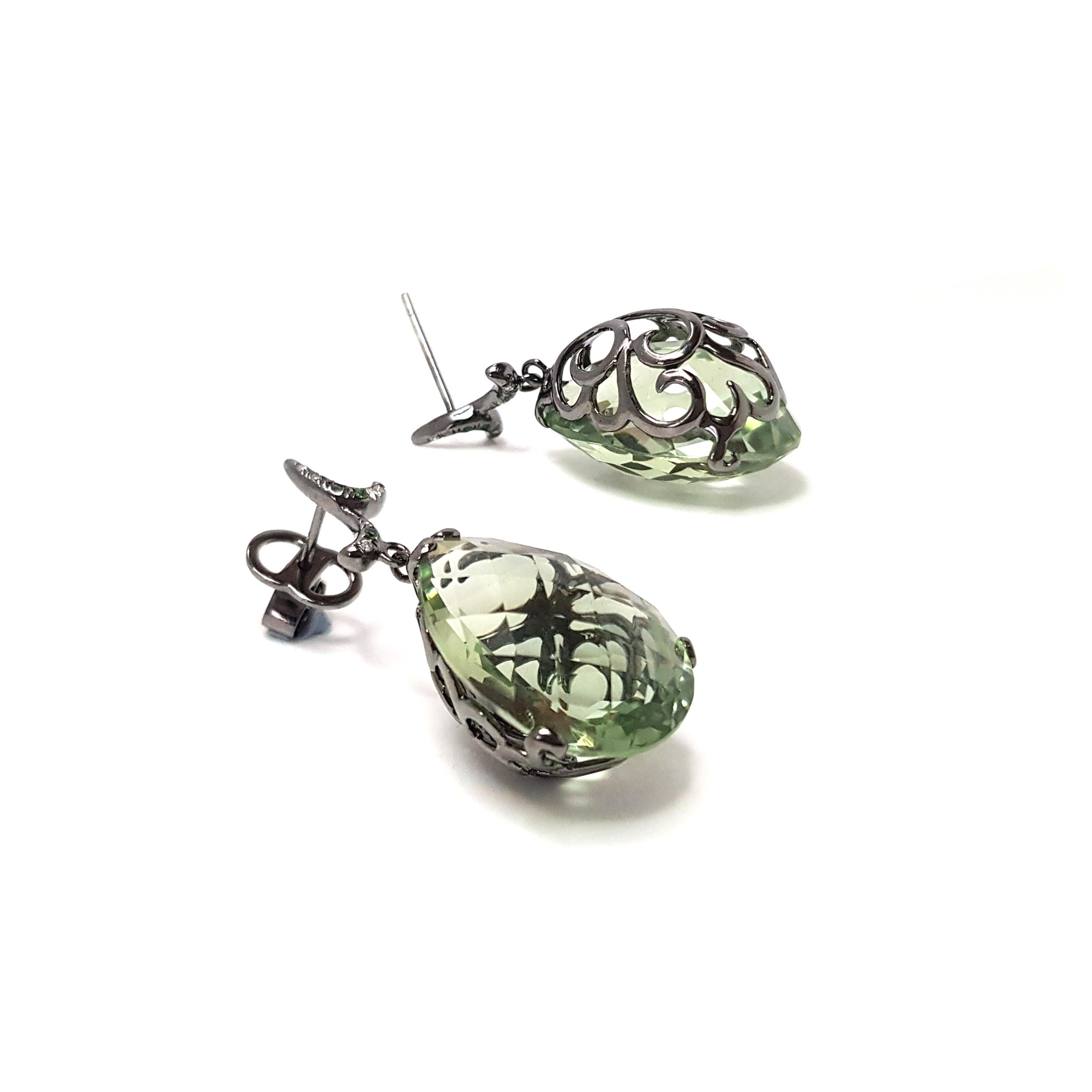 Description:
Whispering small pear stone drop earrings with 8ct green amethyst and 0.04ct diamonds, set in a black rhodium on 18ct white gold filigree setting.

Inspiration:
Emulating femininity and glamour, the Whispering collection is full of