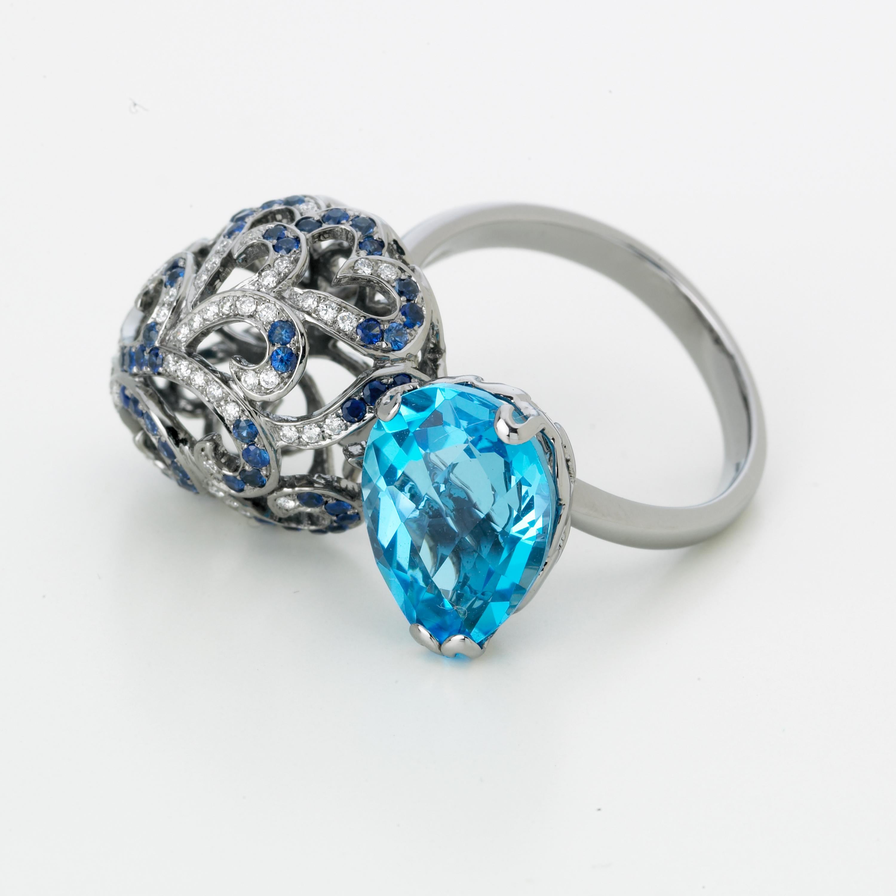 Emulating femininity and glamour, the Whispering collection is full of colour and form. Inspired by the feminine, sculptural shape of the exotic Orchid flower. Whispering large double ring with 4.5ct blue topaz, 0.3ct white diamonds and 0.2ct blue