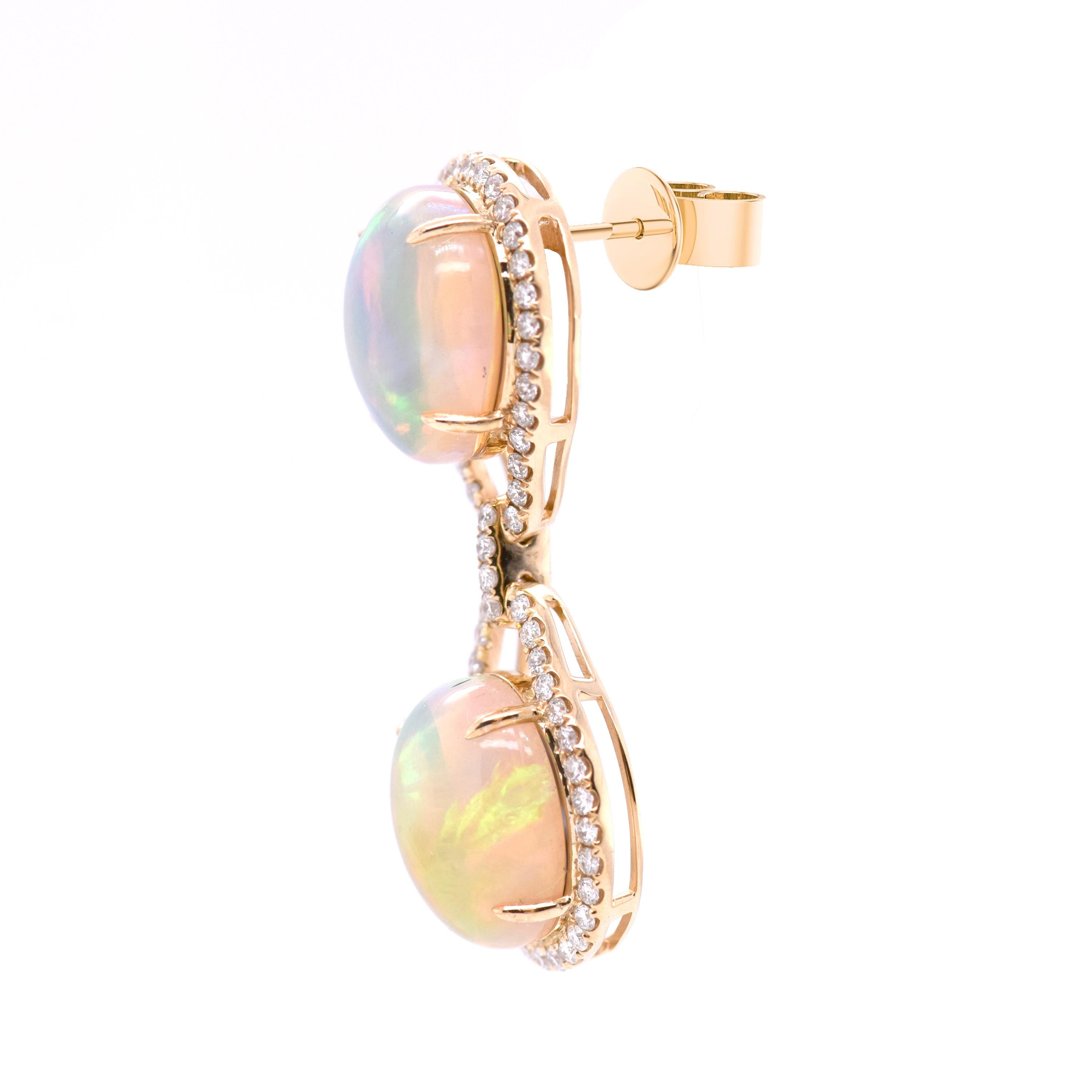 Opulent opal drop earrings in 18ct yellow gold. Featuring colourful opals with a total weight of 14.2ct, bordered with diamonds totalling 0.896ct in weight. 

- Weight per earring: 5.2gm
- Dimensions (HxW): 36mm x 13mm

Fei Liu Fine Jewellery is an