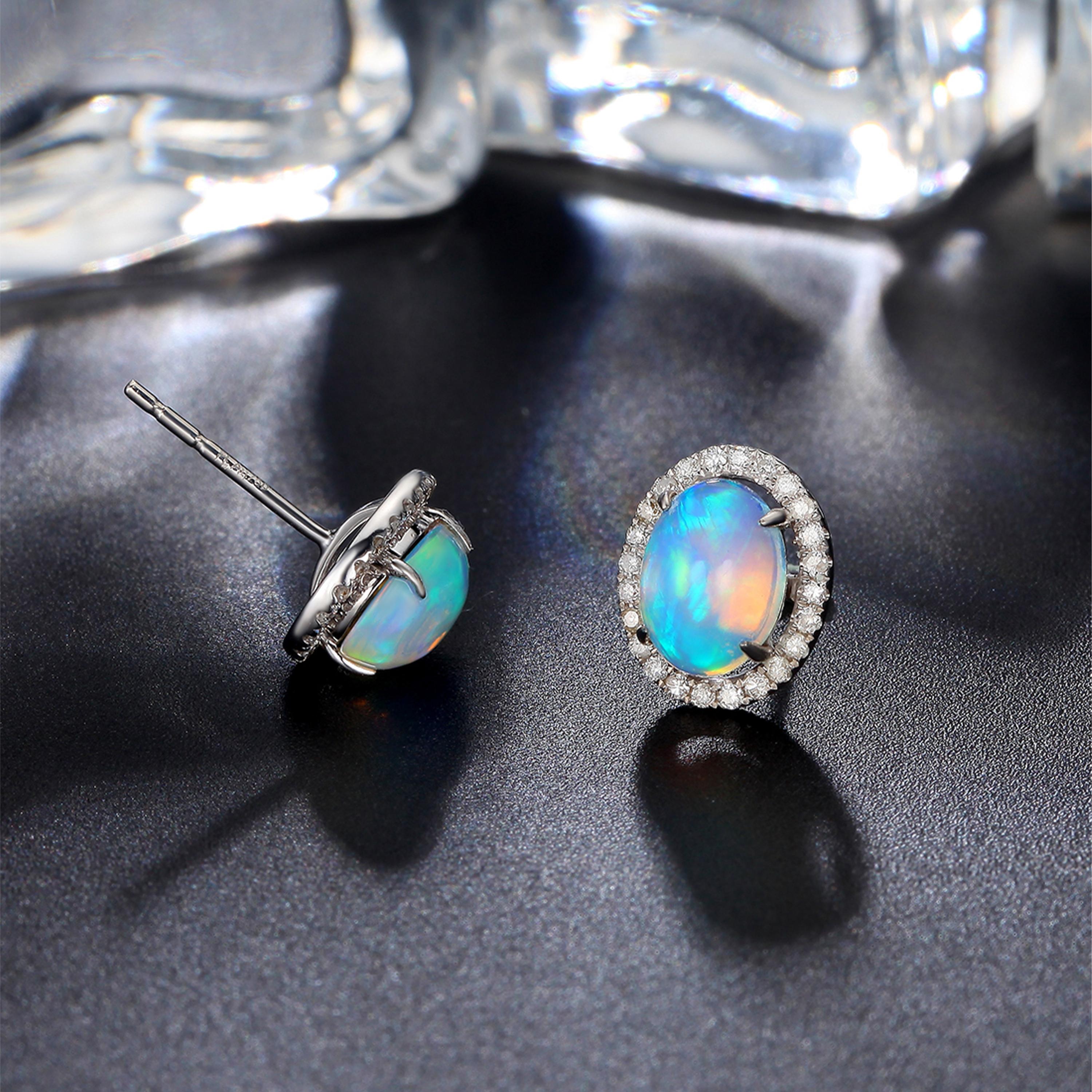 Soft chromatic stud earrings with a classic touch. Yet, an energy of colour to keep you glowing throughout the day and through the night. 

Oval opal stud earrings featuring 1.87ct iridescent opals bordered with shimmering 0.24ct diamonds, set in