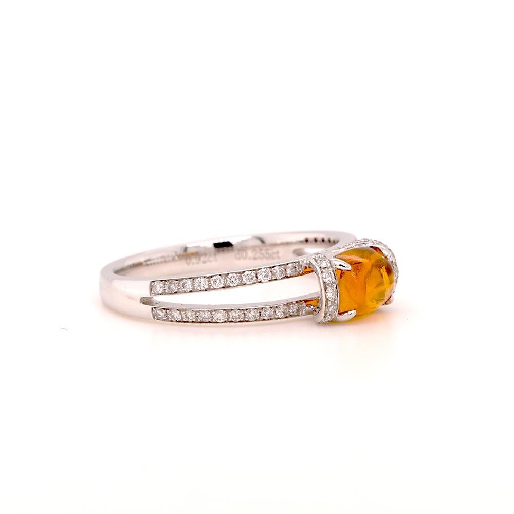 A modern ring featuring a oval citrine decorated with brilliant cut diamonds set in 18ct white gold. The cabochon cut allows the citrine’s natural beauty to shine, showcasing its unique texture and warm yellow-orange colour. Diamonds are often used