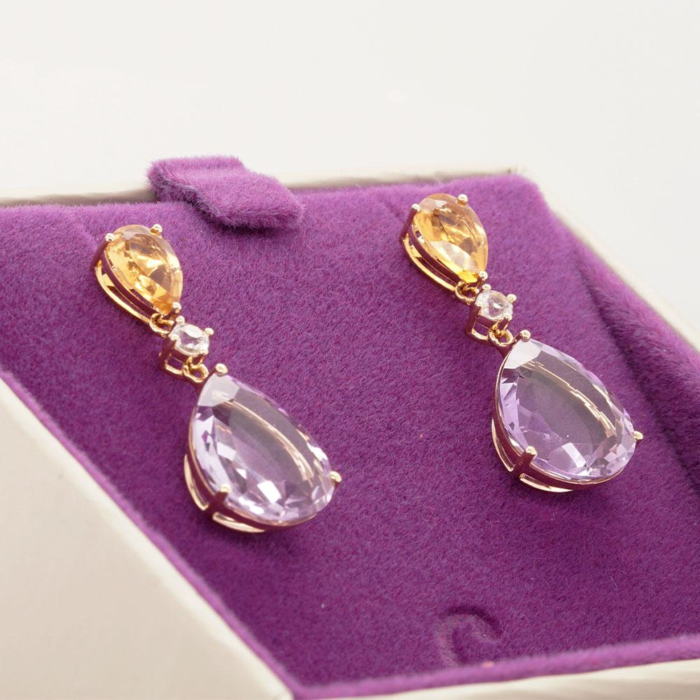 Add a pop of colour to your look with vibrant gems from Mother Nature. These drop earrings feature two pear-cut gems, citrine and amethyst, interspersed with a scintillating sapphire. Each gemstone harmoniously exhibits its beauty within a delicate