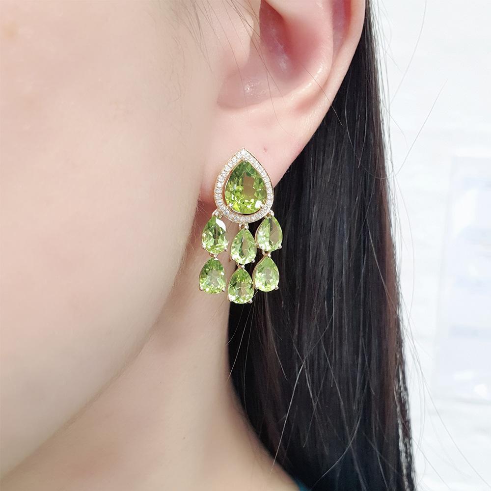 Shine bright in verdant hues with these exquisite mini chandelier earrings. Crafted from 18ct yellow gold, each earring showcases a peridot accented by diamonds, gracefully cascading with even more apple-green peridots.

- Size (LxW): 30 x 15mm
-
