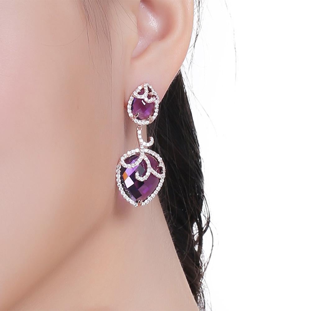 The silver Whispering collection redefines the sumptuous luxury provided by its fine jewellery counterpart, with its exotic shapes derived from the decadent orchid flower. Whispering drop earrings with purple amethysts and white cubic zirconia, set