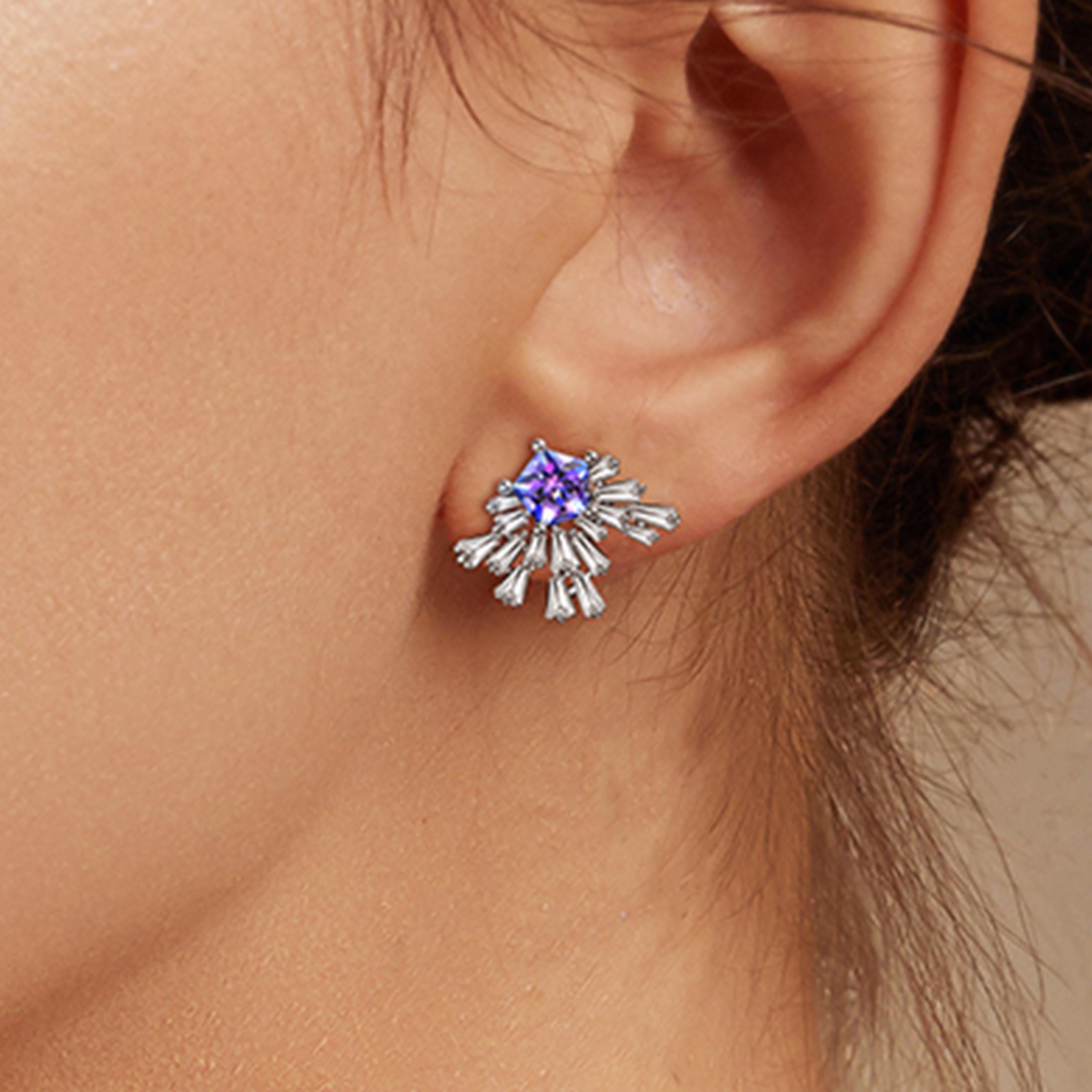 Description:
Light up the room with the new Carpe Diem Collection by Fei Liu! Carpe Diem ‘Fountain’ stud earrings with Swarovski Purple-Aqua Pentagon Star cubic zirconia and 8 hearts and 8 arrows CZ, set in white rhodium plate on sterling