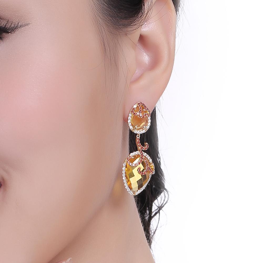 The silver Whispering collection redefines the sumptuous luxury provided by its fine jewellery counterpart, with its exotic shapes derived from the decadent orchid flower. Whispering drop earrings with citrines, white and yellow cubic zirconia. Set