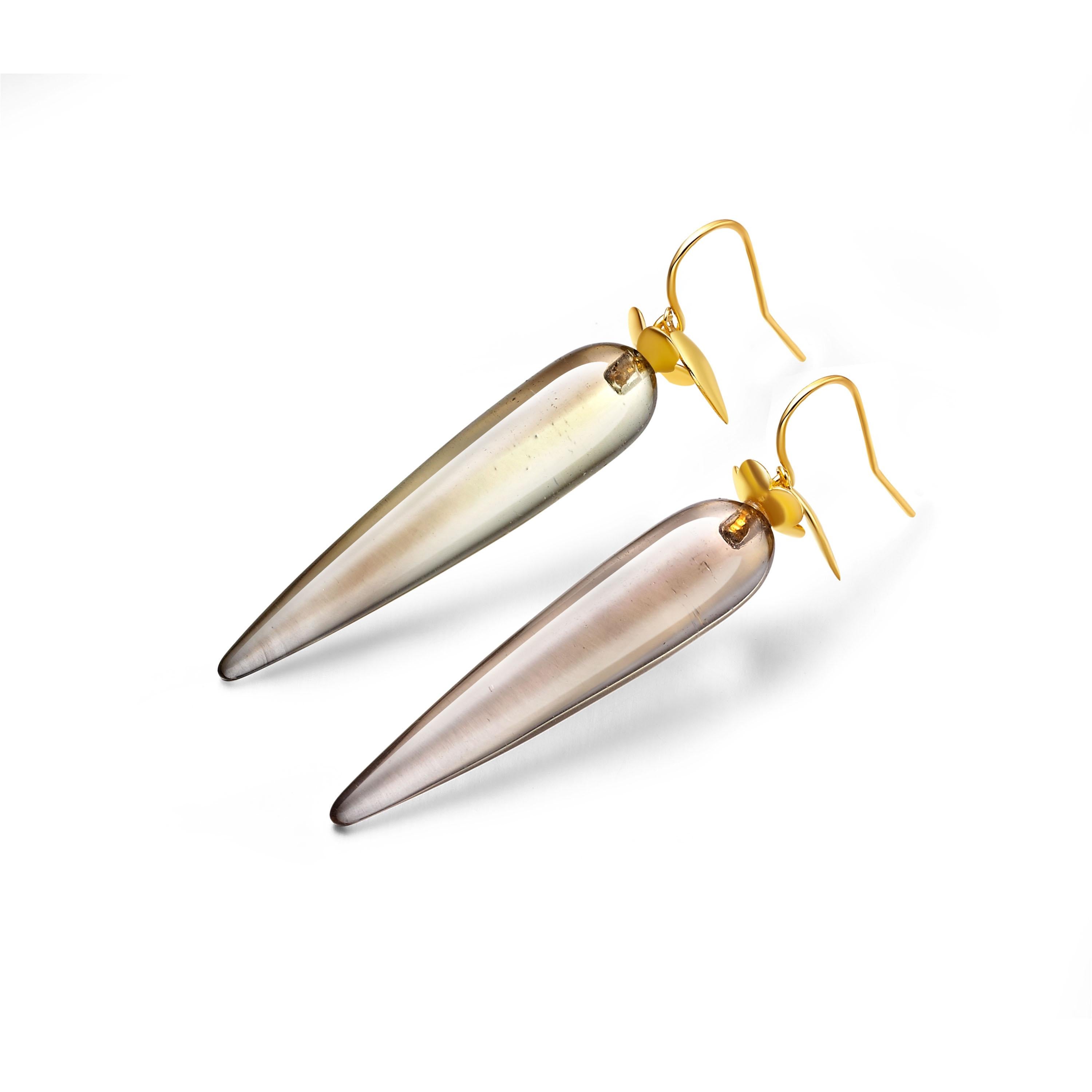 Sophisticated drop earrings featuring teardrops of “stone of power” smoky quartz adorned with delicate petals of 18ct gold plate on sterling silver.

Due to the nature of stones, please bear in mind that the clarity of the smoky quartz may differ