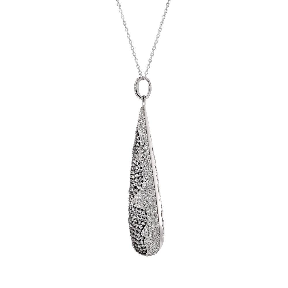 In the ethereal dance of craftsmanship and elegance, behold the sterling silver drop pendant—a testament to sublime artistry and timeless allure. Suspended delicately from a 18” chain, the pendant takes the form of a hollow teardrop, its exquisite