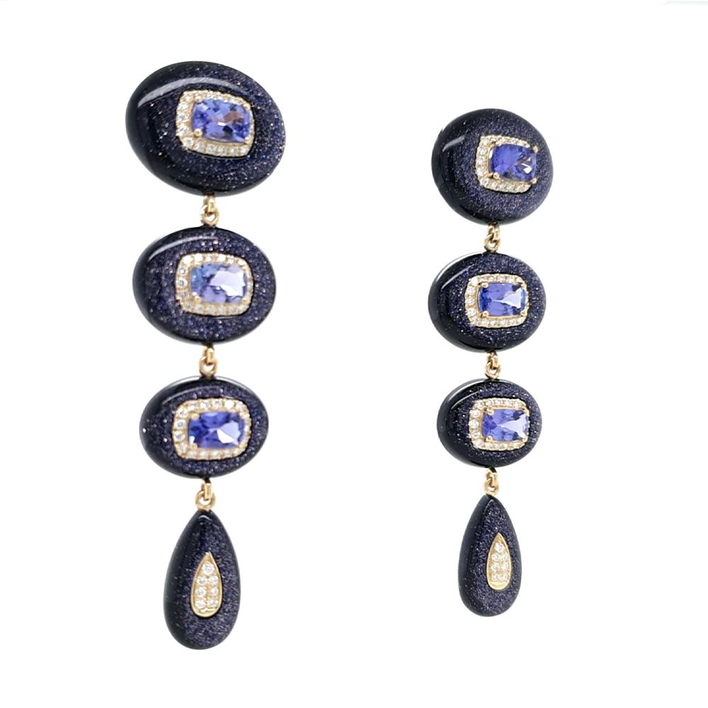 A captivating pair of graduated drop earrings, exquisitely crafted in 18ct yellow gold. Each earring features a cascading series of mesmerising tanzanites, their rich violet-blue hues beautifully enhanced by sparkling diamond halos. Interspersed