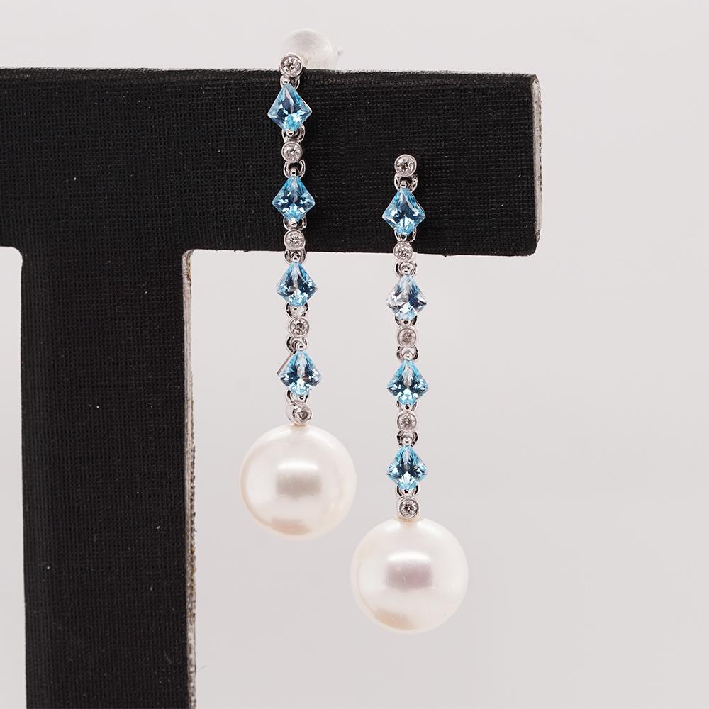 A stunning blend of topazes, diamonds, and lustrous pearls. These elegant earrings effortlessly capture attention and add a touch of timeless beauty to any ensemble.

Each earring features a cascade of vibrant topazes, descending gracefully in size.