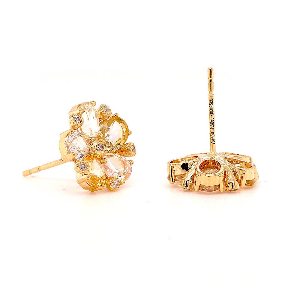 A pair of charming yellow sapphire stud earrings. Glistening with radiant splendour, each earring showcases a mesmerising bouquet of vari-hue yellow sapphires and diamonds, delicately arranged in an 18ct yellow gold setting. Like a sun-kissed