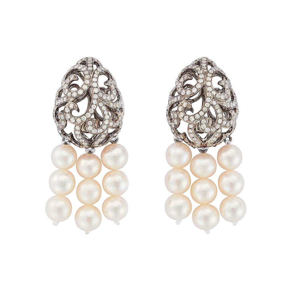 The Whispering Pearl Tassel Earrings are a breathtaking symphony of elegance and movement. Suspended from diamond-embellished, openwork filigree eggs, exquisitely crafted in black rhodium plate on 18ct white gold, each earring shimmers with delicate