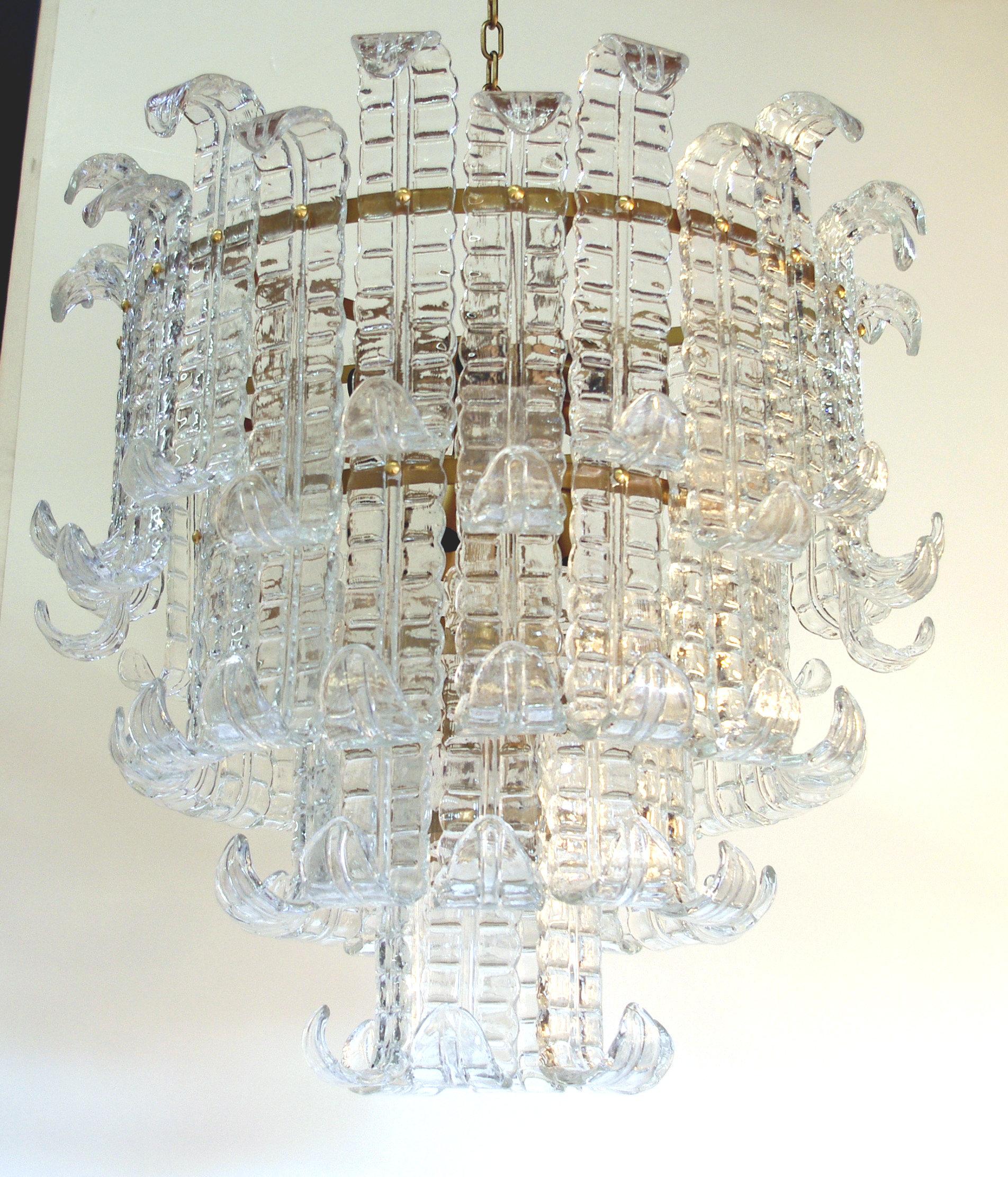 Italian chandelier shown with four tiers of clear hand blown Murano Felci fern glasses mounted on bronzed finish metal frame, by Fabio Ltd / Made in Italy
10 lights / E26 or E27 type / max 60W each
Diameter: 31.5 inches / Height: 27.5 inches plus