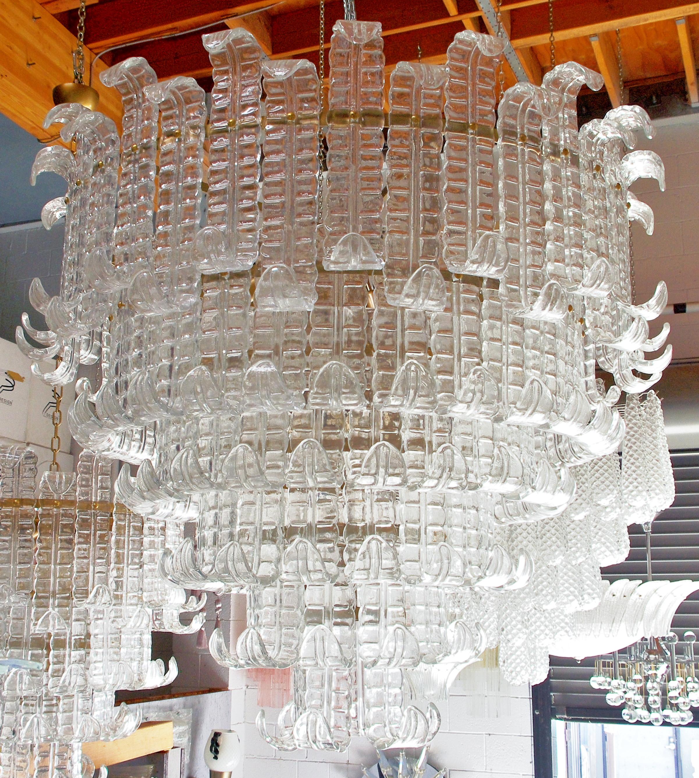 Italian chandelier shown with six tiers of clear hand blown Murano Felci fern glasses mounted on bronzed finish metal frame, by Fabio Ltd / Made in Italy
22 lights / E26 or E27 type / max 60W each
Diameter: 43.5 inches / Height: 39.5 inches plus