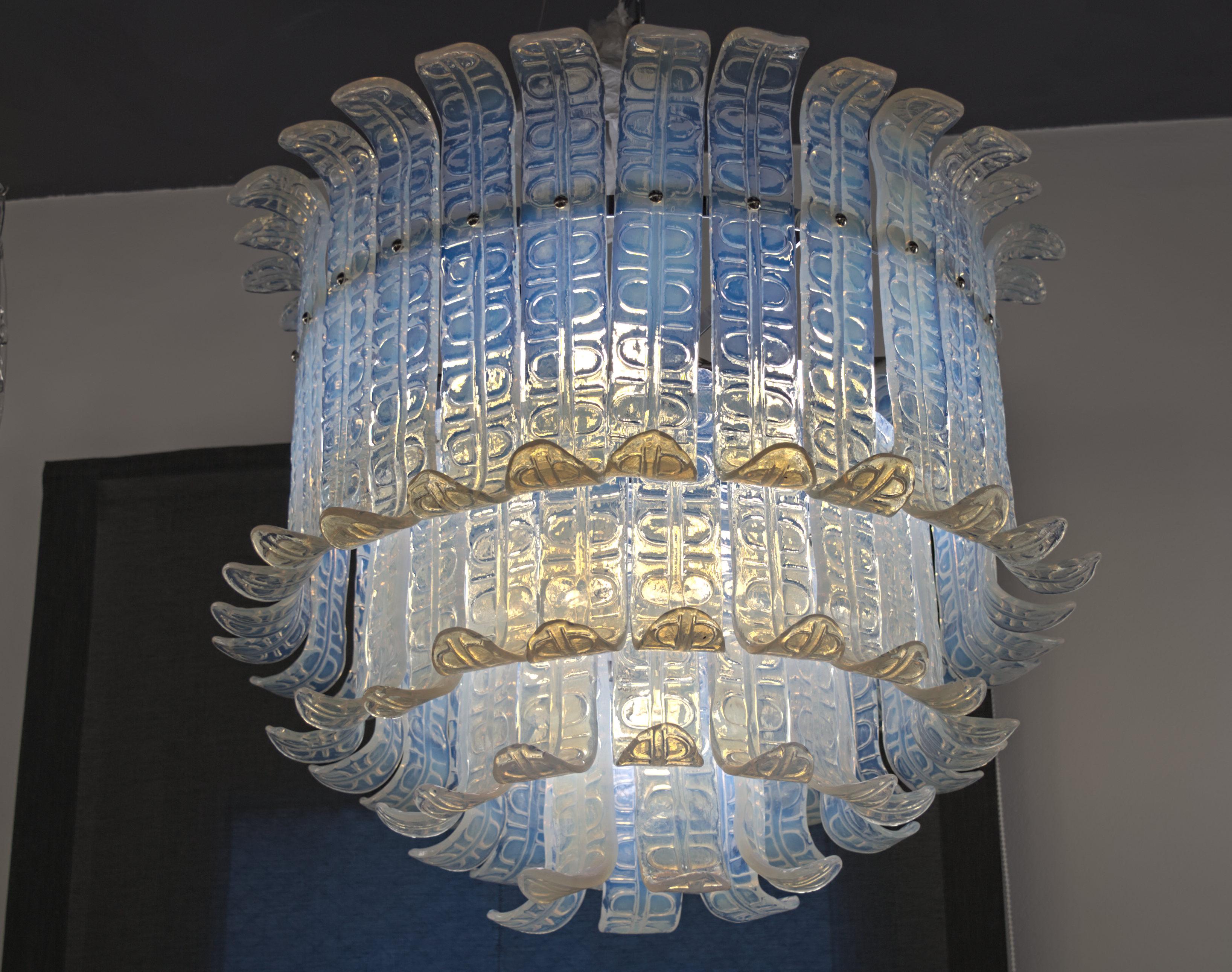 Great midcentury chandelier. Four tiers of Felci elements to tightly fence the bulb and the hardware. 
Hard to find true opaline glass which shows his unique fading from blue to amber.

Piastra technique. Opaline glass is poured over a mold with