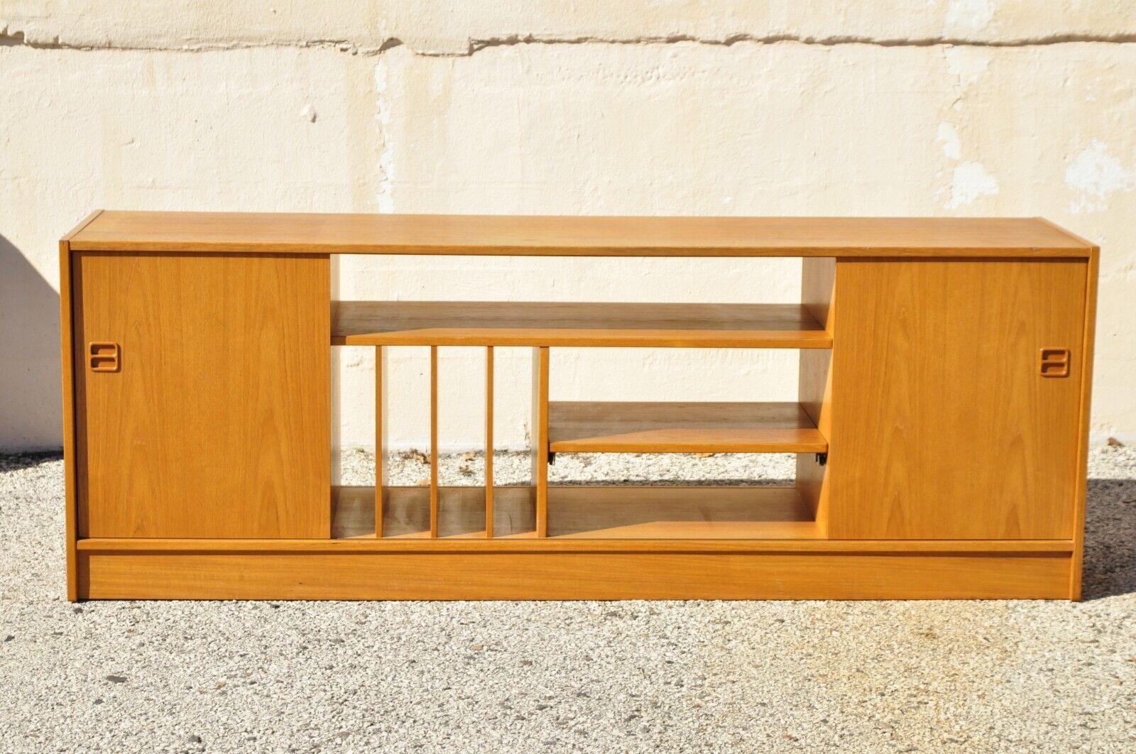 Feldballes Mobelfabrik Danish Modern teak record credenza media cabinet. Item features (1) Pull out shelf, (2) sliding doors, multiple compartments for records, beautiful wood grain, original label, clean modernist lines, great style and form. Circa