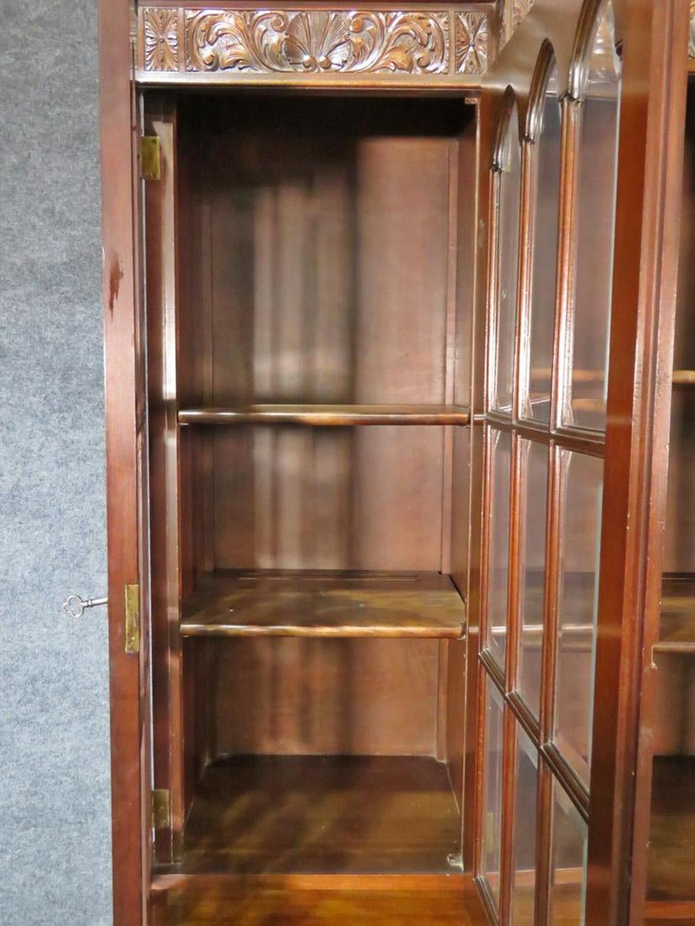 Gorgeous Feldenkrais of Philadelphia Federal style solid mahogany breakfront bookcase. Beveled glass. Six drawers. Two doors containing one shelf each. Three glass doors on top each containing two shelves. 80 1/2