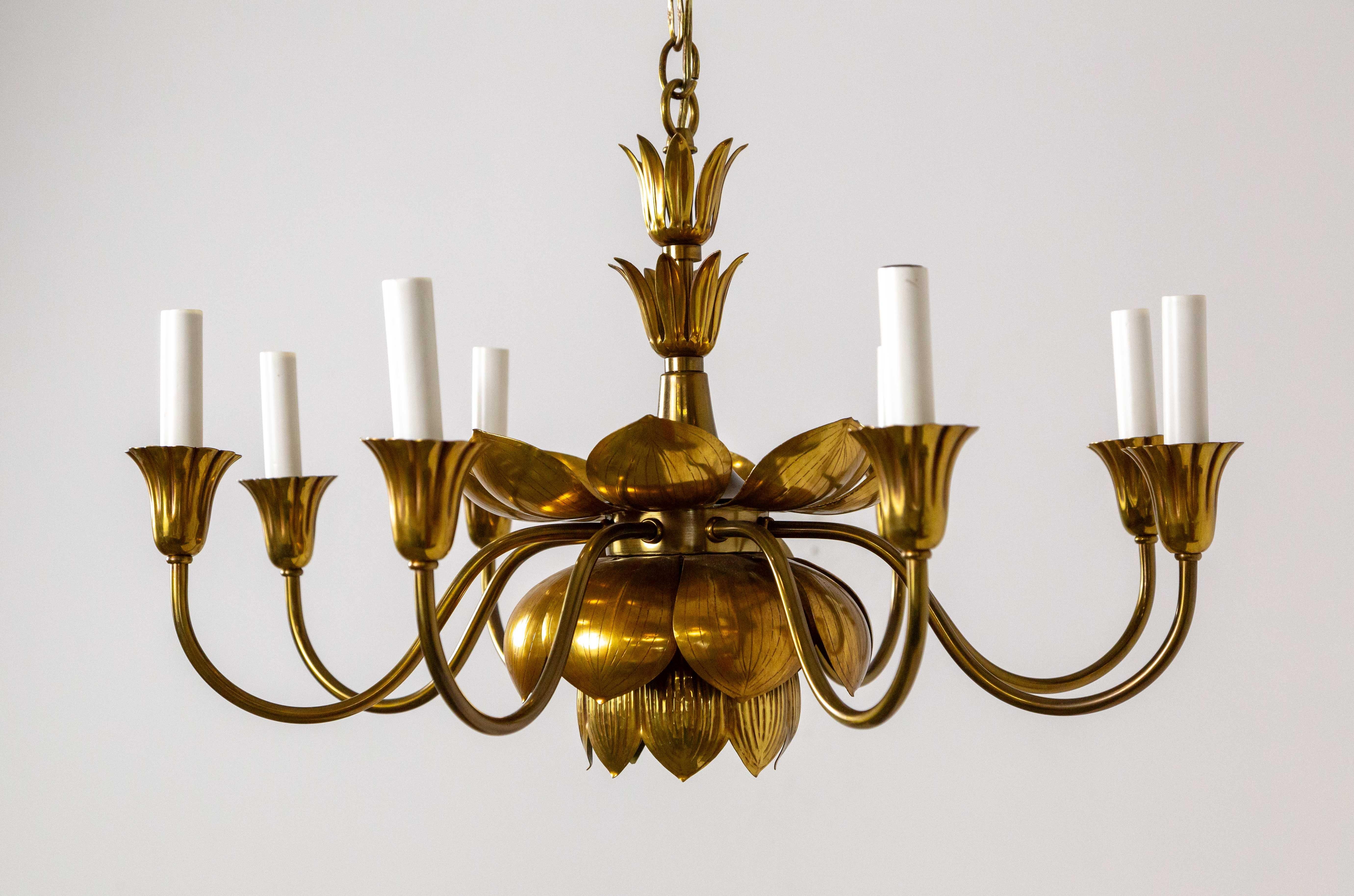 A sculptural, brass lotus chandelier produced by Feldman Company of Los Angeles, CA in the 1960s. This is a rare design- with 8 candlestick arms- as opposed to the smaller, pendant version.  It's a beautiful Hollywood Regency fixture in the style of