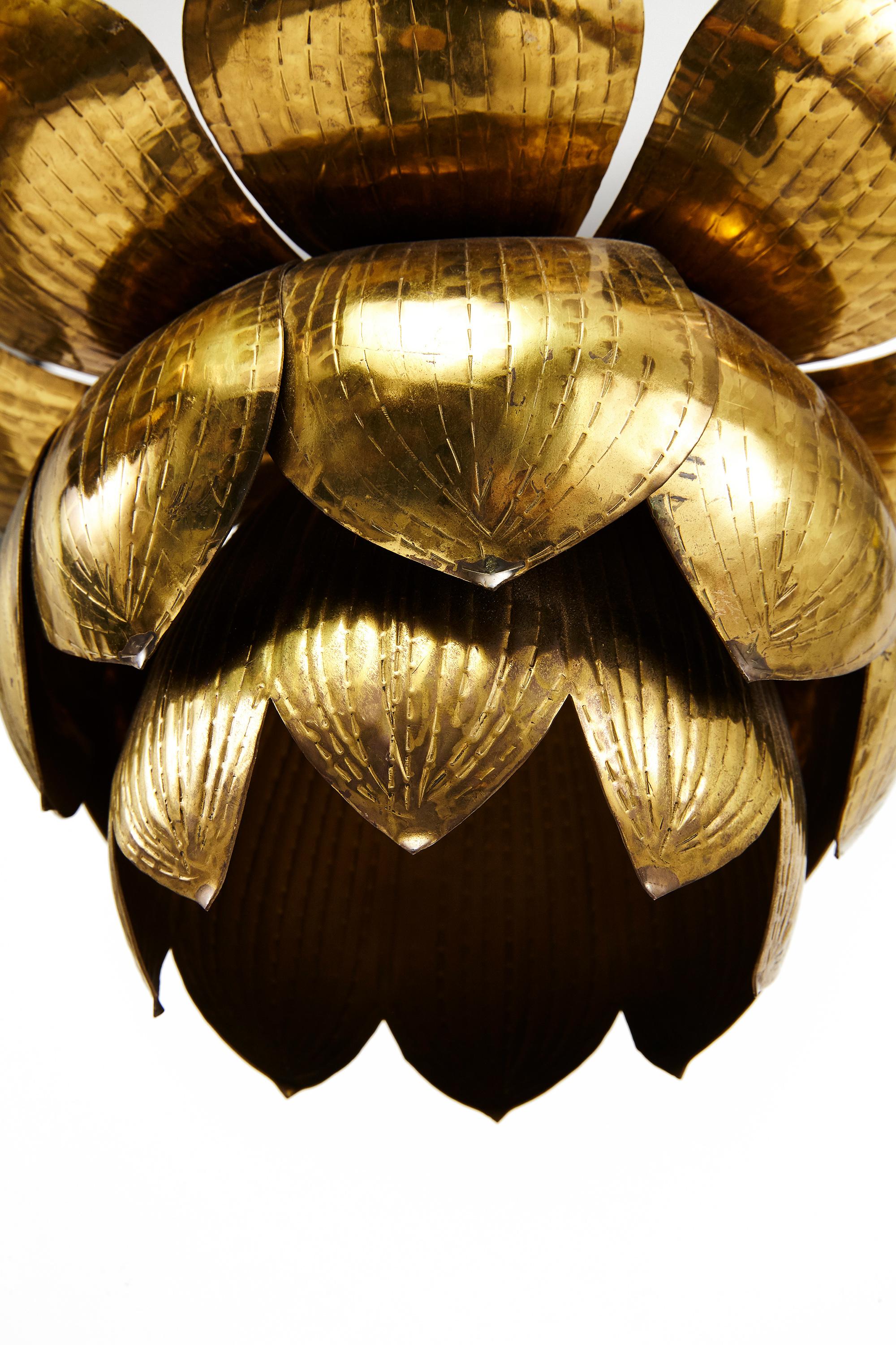 Stunning brass lotus pendant light fixtures by the Feldman Lighting Company, circa 1960. These highly glamorous Hollywood Regency style fixtures are in the organic shape of a lotus flower. Currently we have 6 available in this size as well as a pair