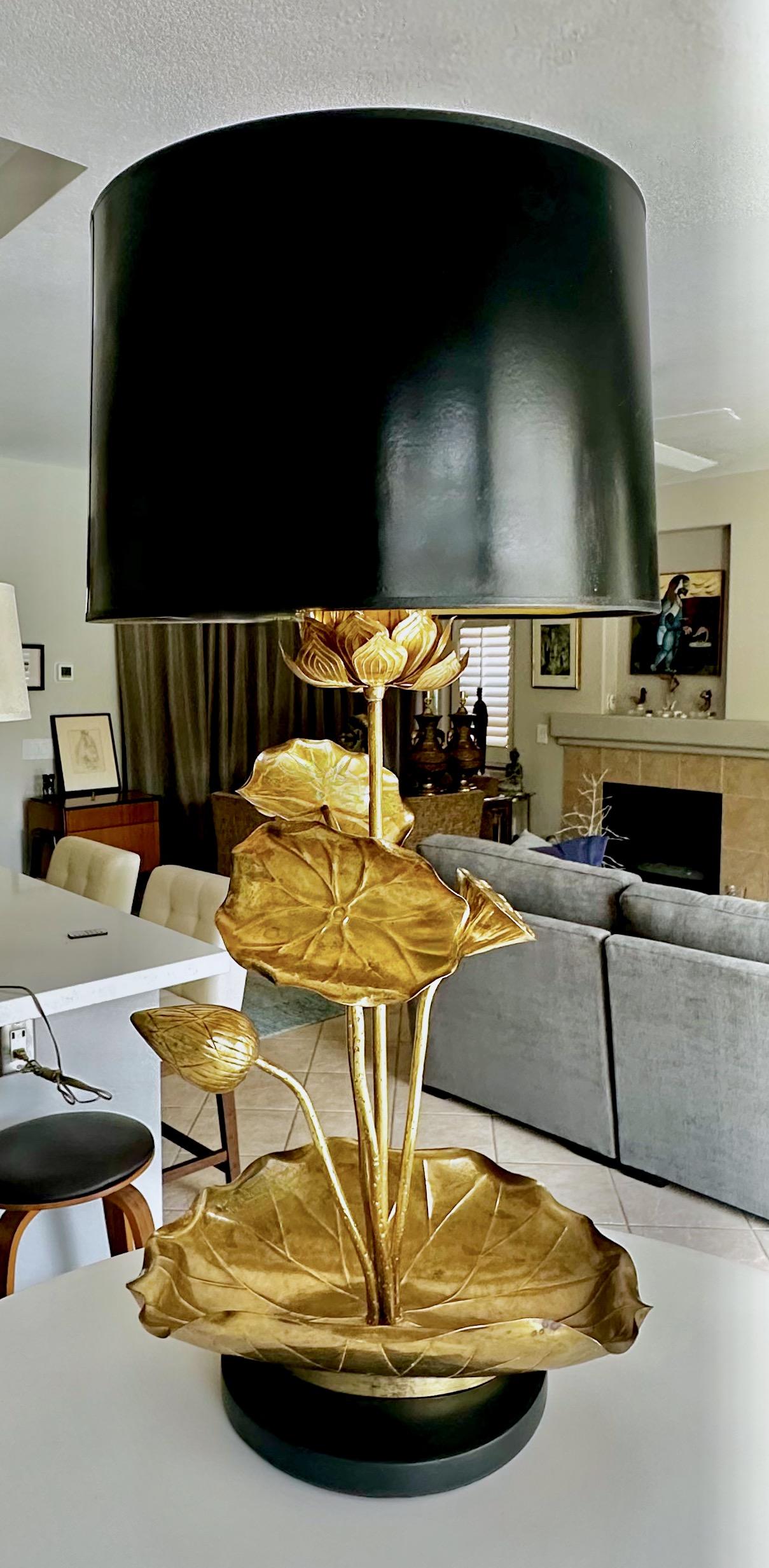 Brass sculptural repousse lotus blossom table lamp on a black lacquered base, by Feldman Lighting (often described as in the style of Tommi Parzinger). In addition to the large main center lotus blossom also includes several lotus leaves and blossom