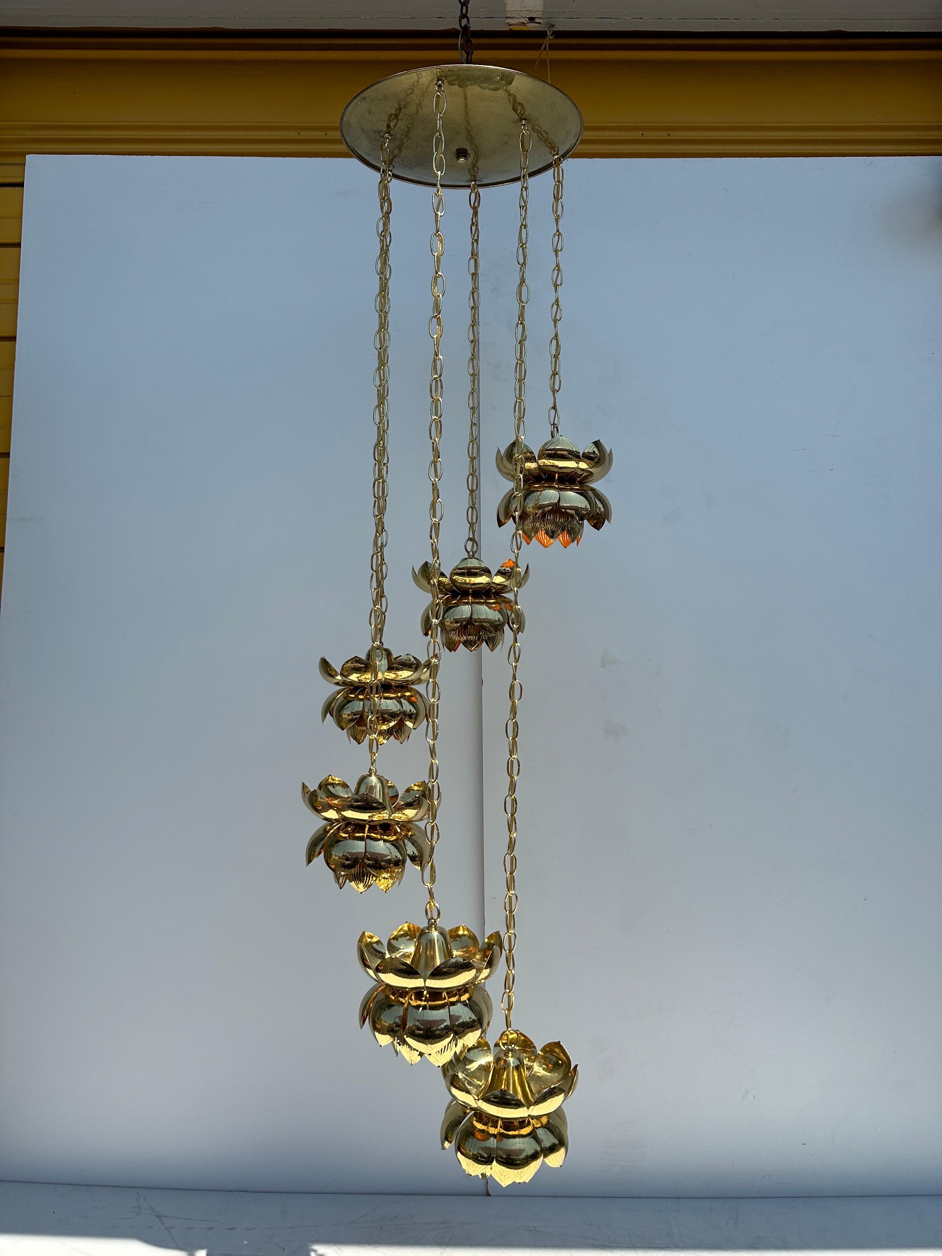 Feldman six light brass lotus chandelier newly polished and lacquered. Canopy is 18” diameter. Longest lotus is 72” and shortest 29”
Requires up to 60watt E27 base bulbs.