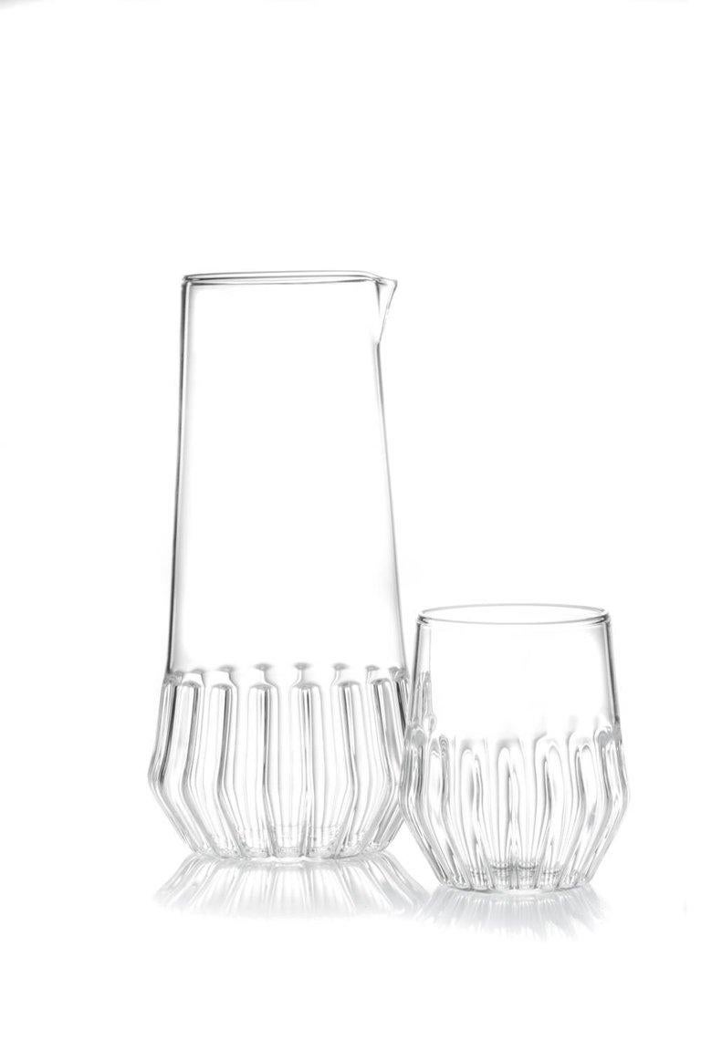 This set includes one mixed carafe and six mixed small glasses. 

This item is also available in the US.

With a special technique, the modern Mixed collection combines two types of glass to create this modern collection. Retro yet contemporary it