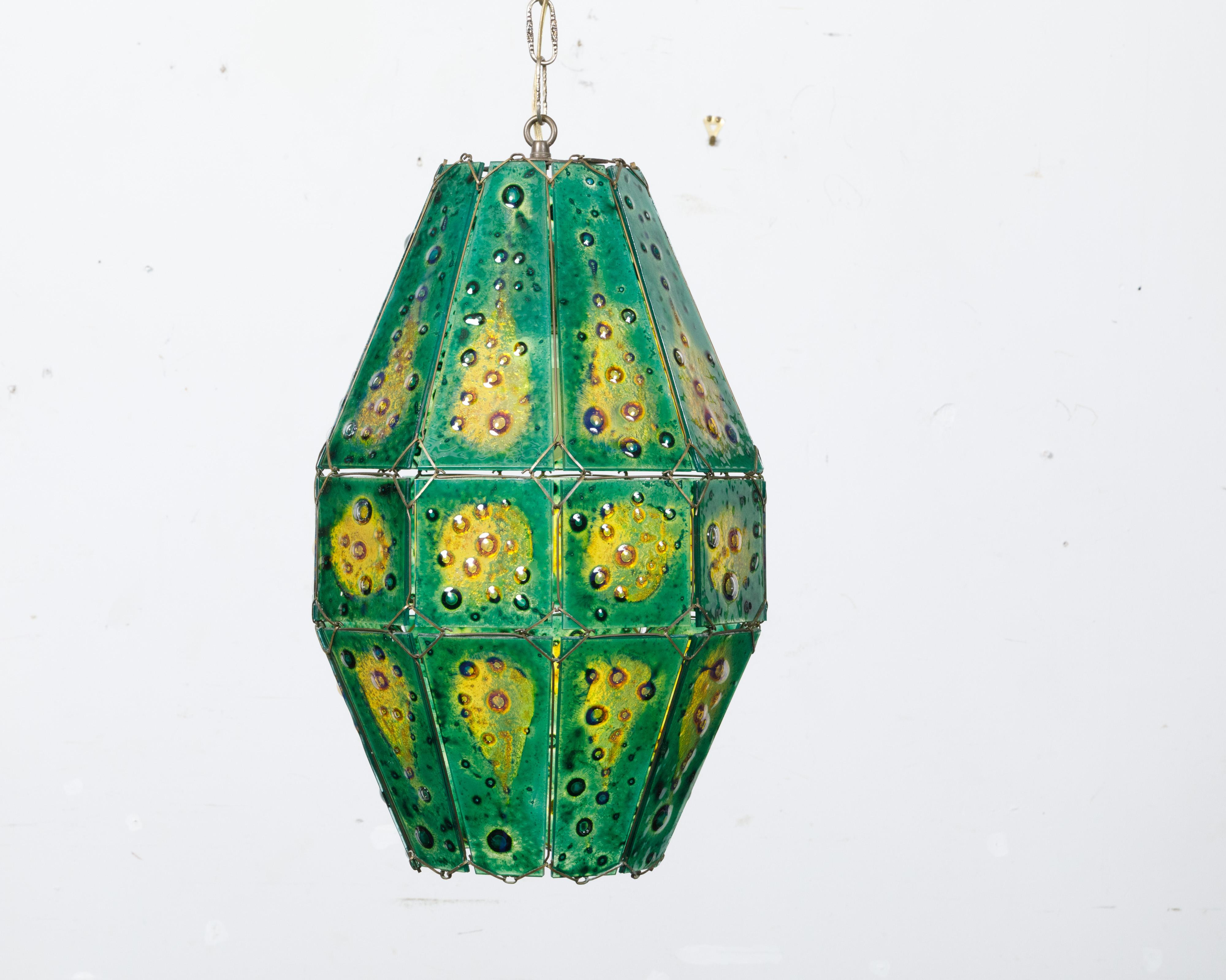 A Felipe Derflingher art glass pendant light fixture from circa 1970 with green and yellow tones. Crafted by the esteemed artist Felipe Derflingher around the 1970s, this art glass pendant light fixture is a brilliant representation of mid-century