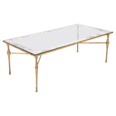 Tavolo basso con piano in vetro e struttura in bronzo dorato Felix Agostini