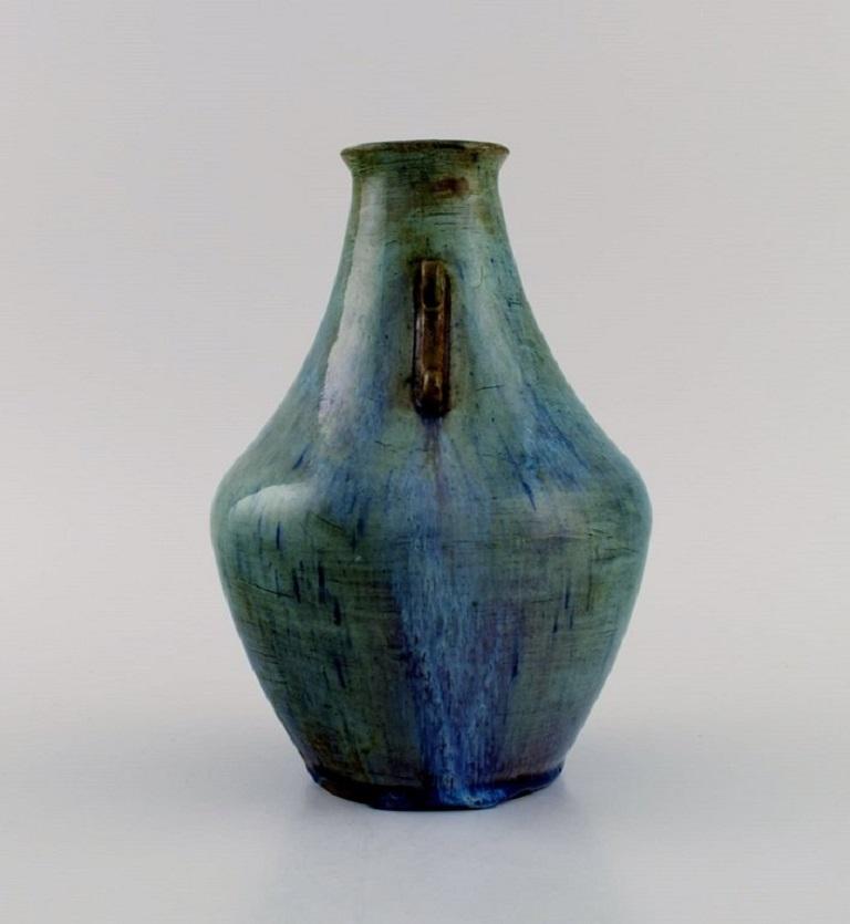 Felix-Auguste Delaherche. French ceramist (b. 1857, d. 1940). 
Art Deco ceramic vase. Beautiful glaze in blue-green shades. 1920's.
Model number 7047.
In excellent condition.
Stamped.
Measures: 18 x 13 cm.

Felix-Auguste Delaherche graduated