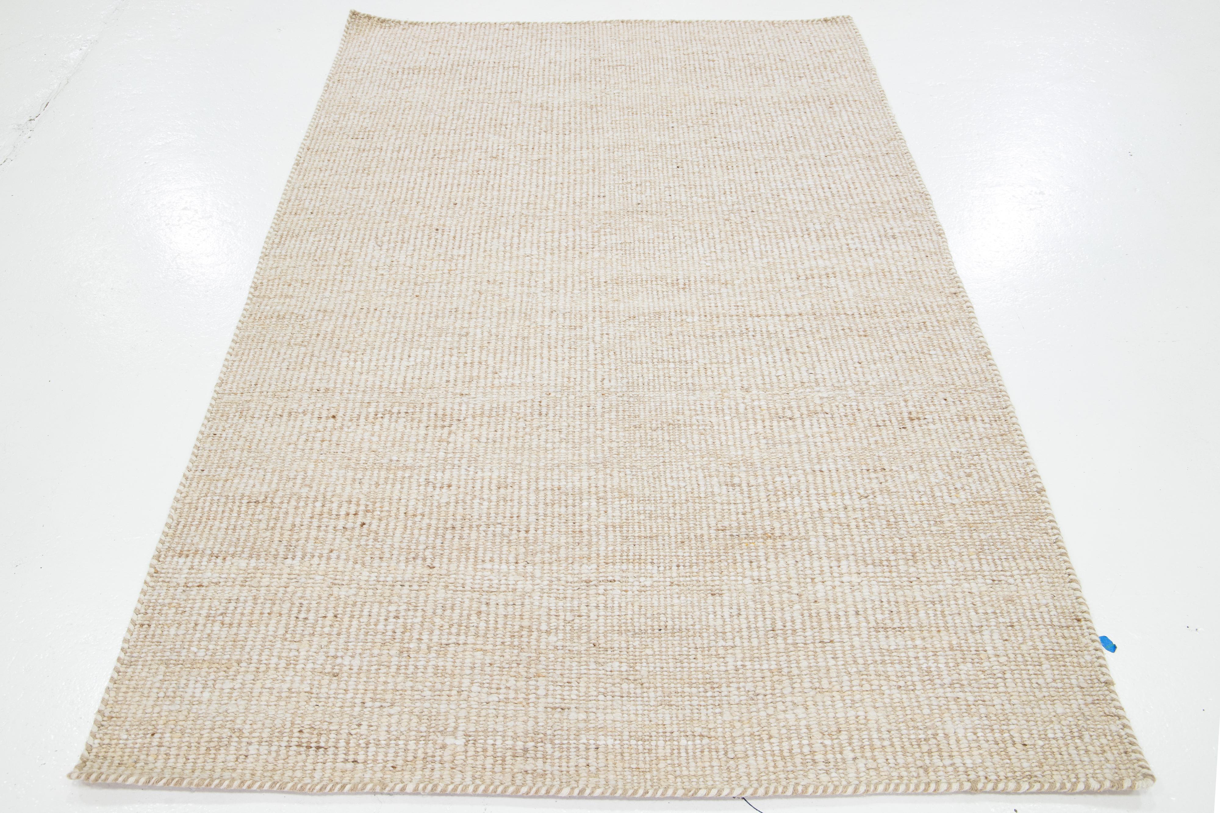 This beautiful Felt hand-woven wool rug is part of our Westport Collection. It has a beige field geometric design throughout.

This rug measures 5' x 8'.

Custom colors and sizes are available upon request.

