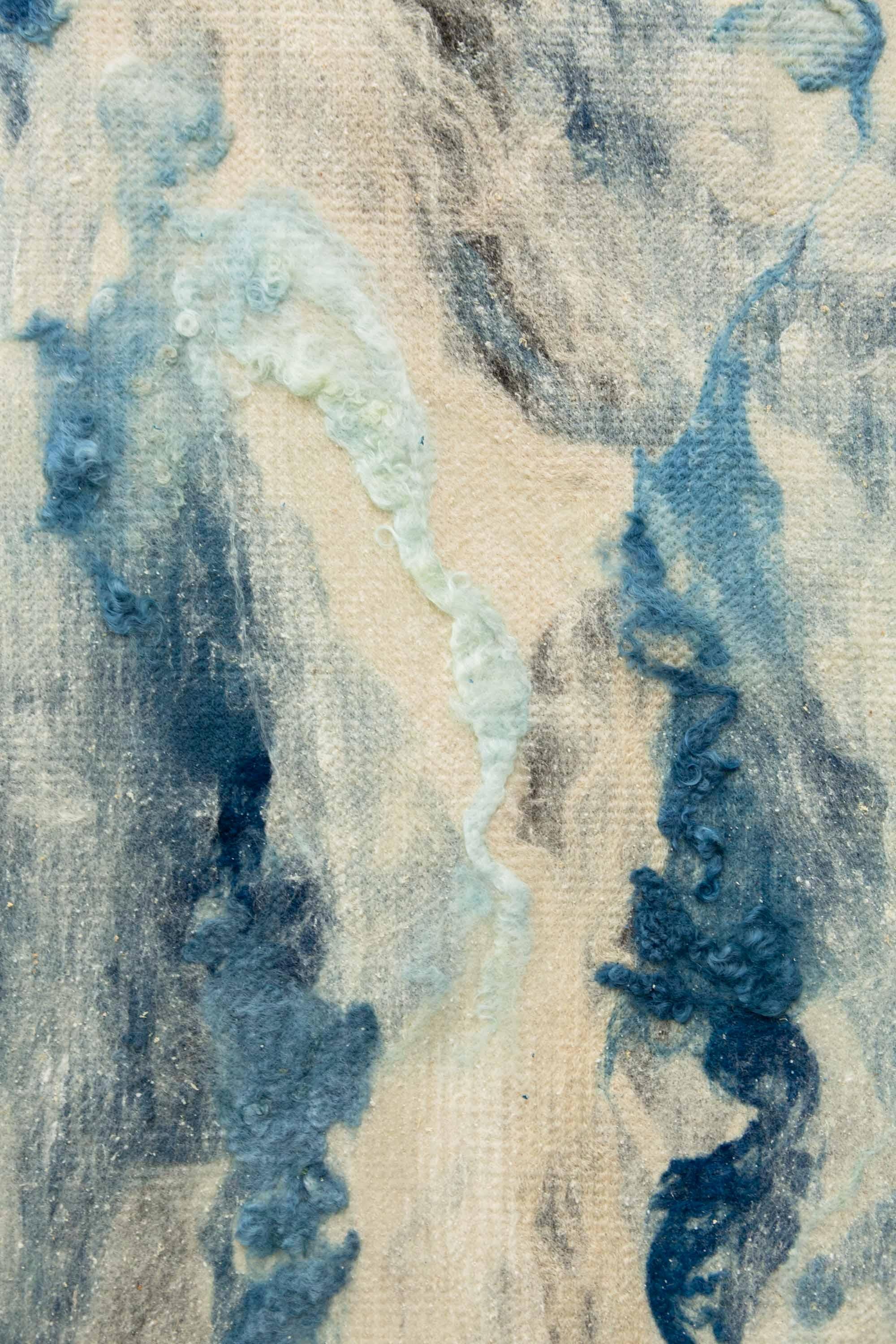 WATER FINDS A WAY, felted during the seemingly endless river of water that fell from the California sky during the winter of 2023, was painted with indigo vat dyed raw wool, seaweed carded with wool, and raw silk on a canvas of locally sourced wool.
