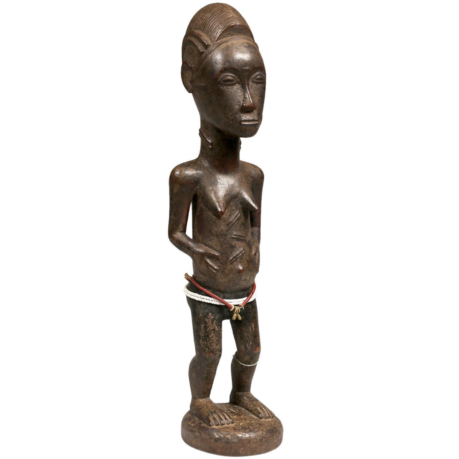 1st Half 20th Century Female Baule Figure, Ivory Coast, Africa

A stylistically pleasing figure. The soft brown patina and fine carving impart a delicacy that I don’t usually associate with figures of spiritual spouses (blolo bian). With Classic