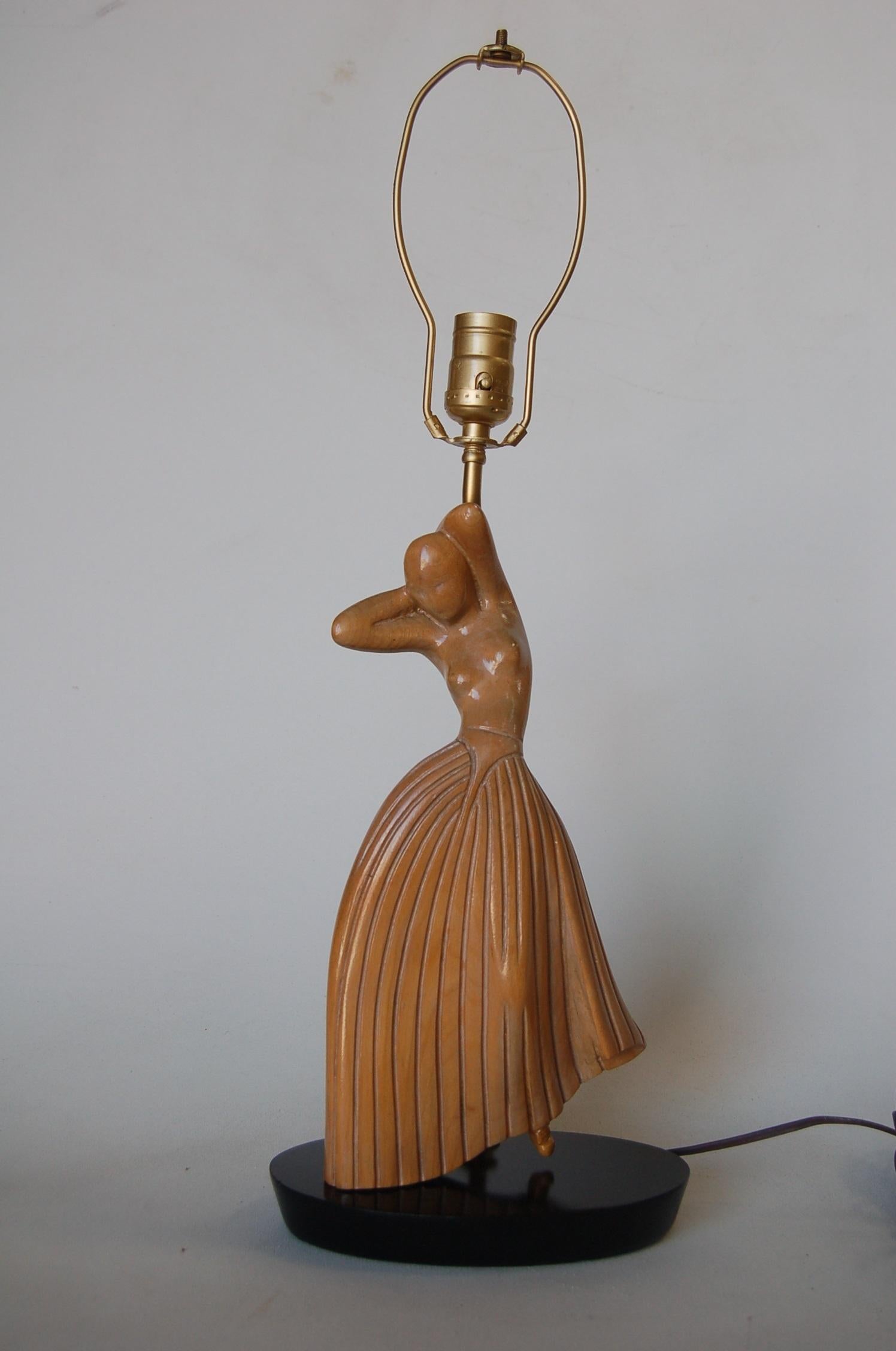 Carved oak female figure dancer table lamp in the style of Jascha Heifetz.

Measures: 18