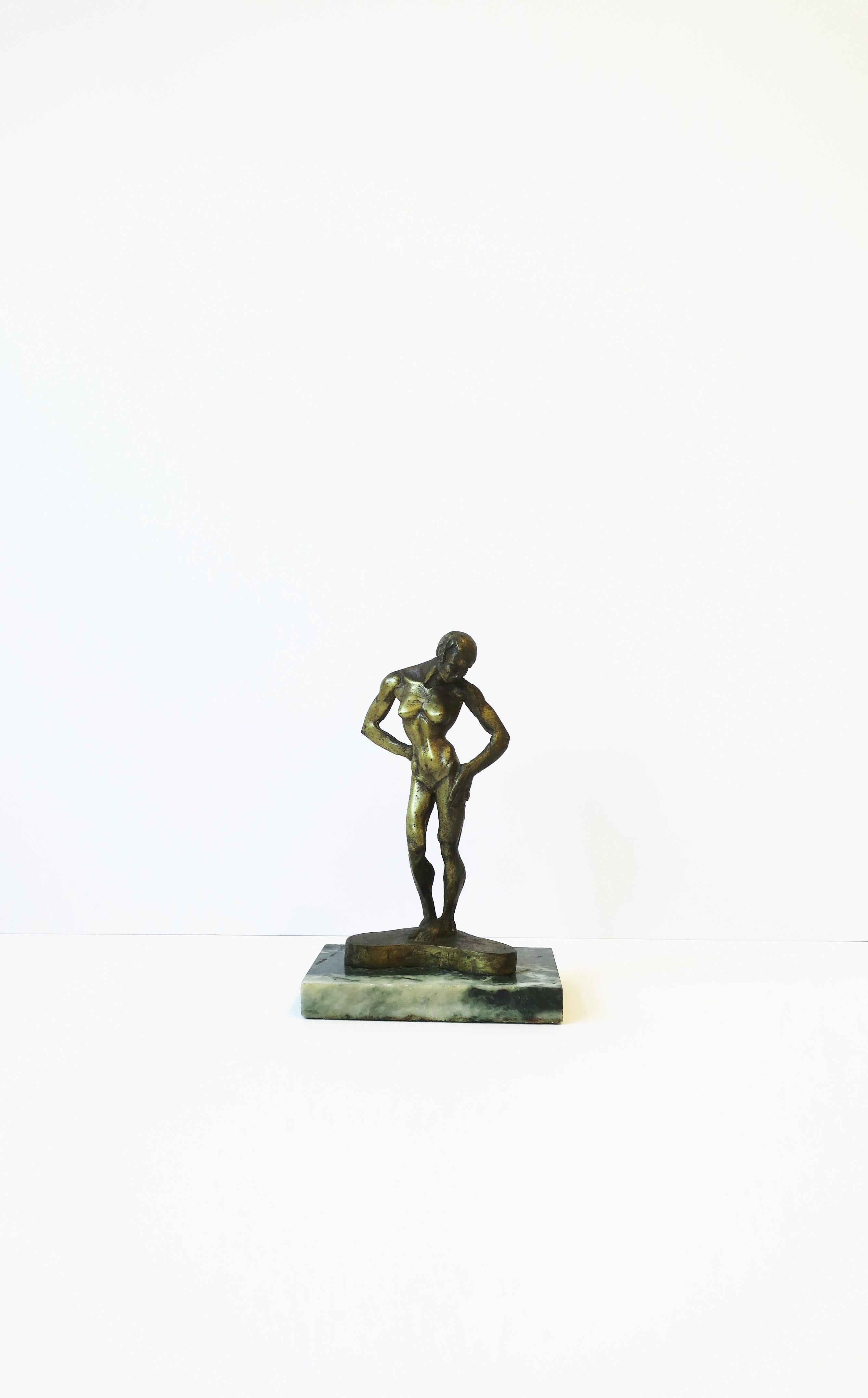 A beautiful and substantial signed and numbered female figurative gilt bronze sculpture on a dark green with white veining marble base, by sculptor Michael Shacham, 1977. A beautifully toned female figure bronze sculpture in the Art Deco design