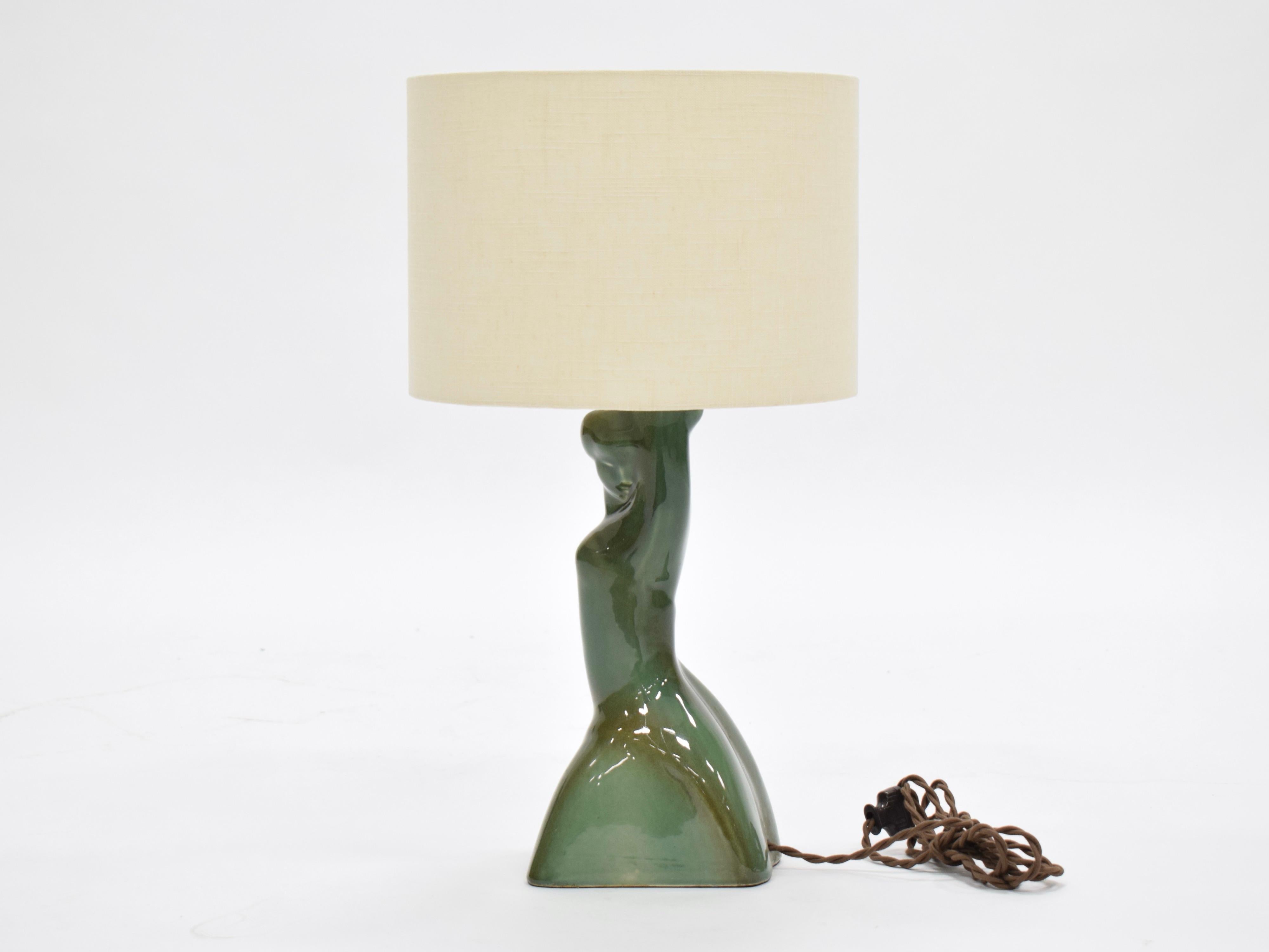 This ceramic female form table lamp has a beautiful green glaze that creates a lovely depth and dimension. Newly rewired for US.  Shade not included.