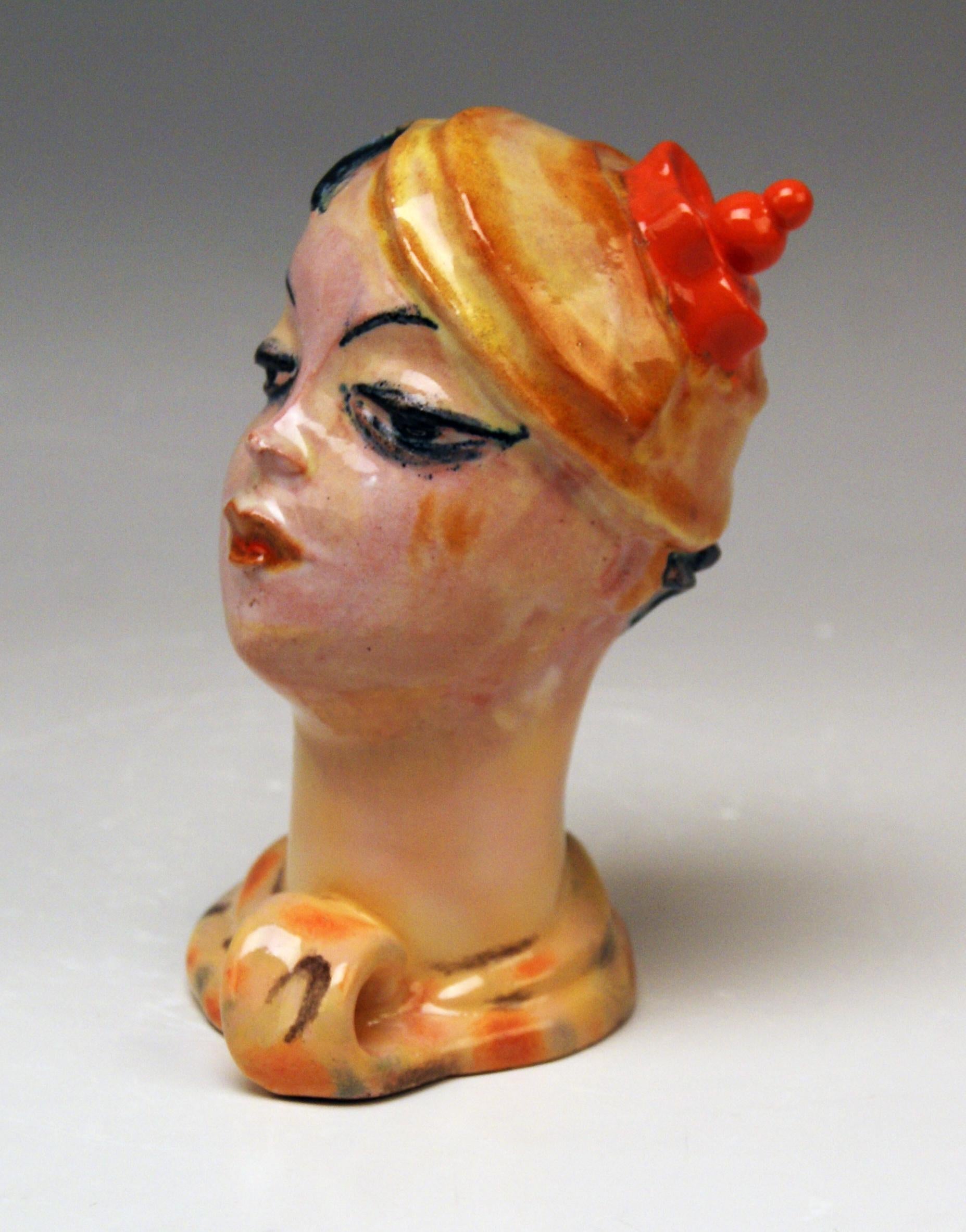Sculptured Female Head made in excellent style of Expressionism, designed by Vally Wieselthier (1895-1945)
made circa 1928
red earthenware, multicolored painted and glazed (= colored via on-glaze paints)

It is a sculptured female head attached
